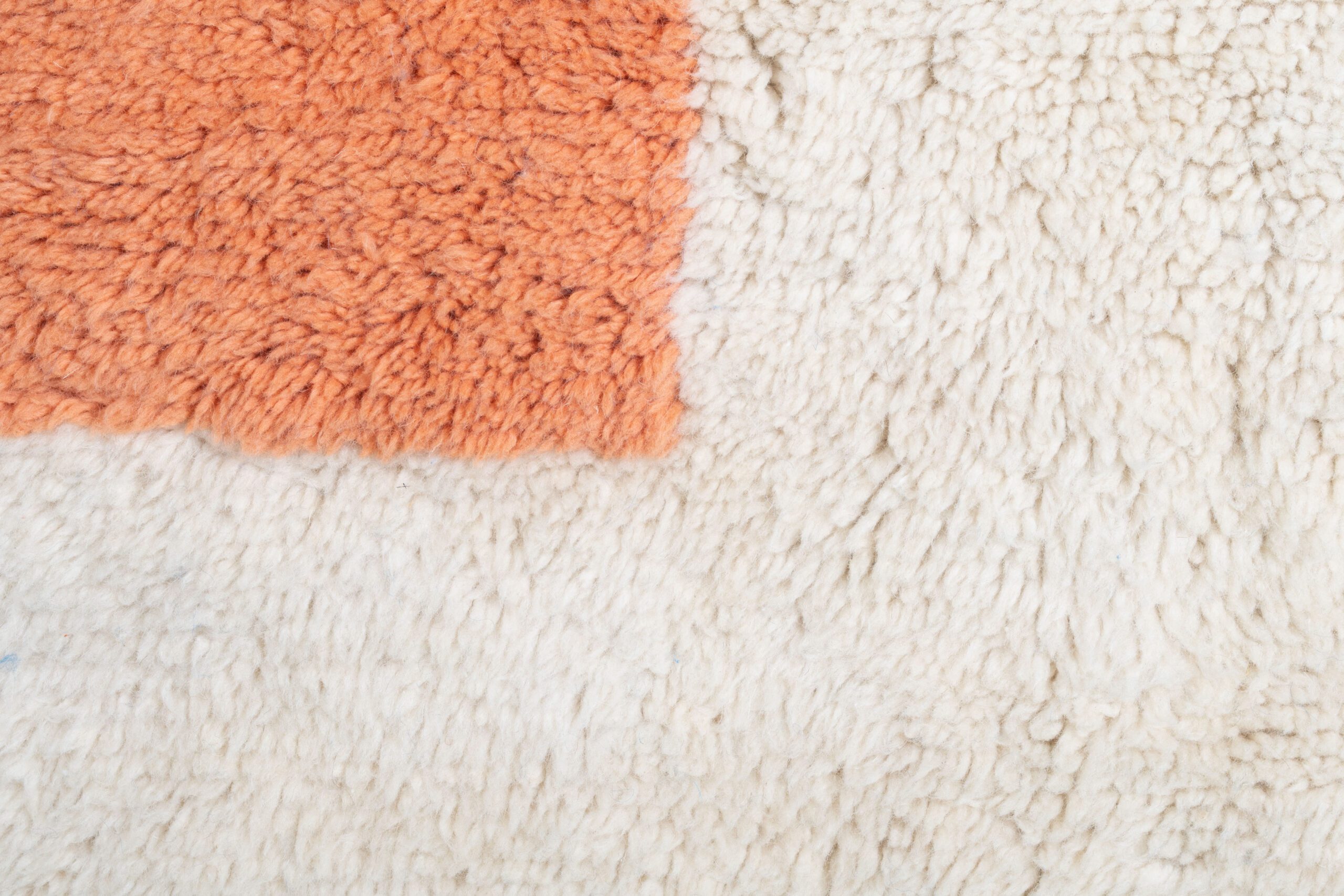 a white and orange rug with a cat laying on it. VIN071_W-40_OR-26_BL-03_PN-92 (6)