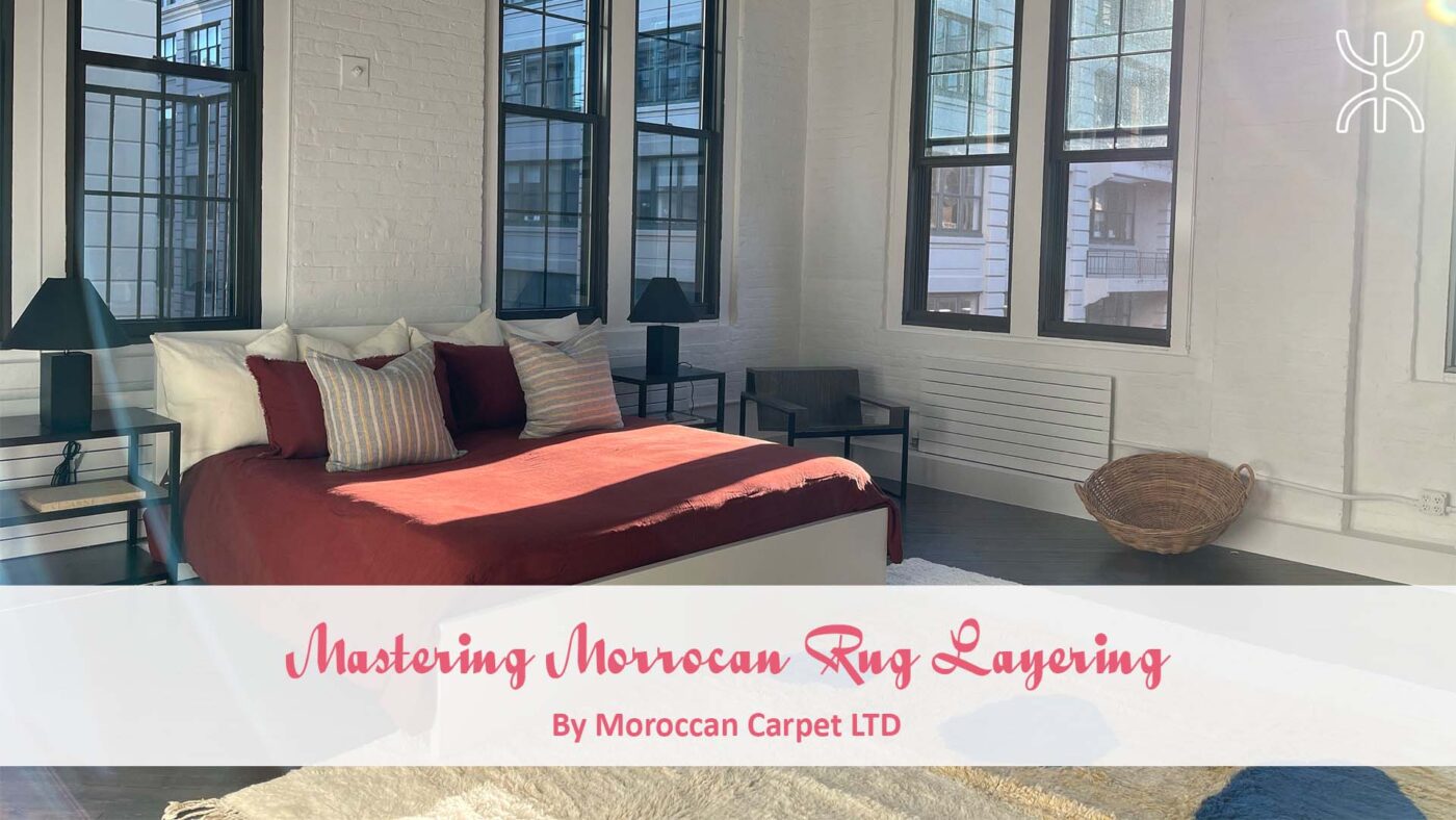a bedroom with a bed and a red moroccan rug. Mastering Morrocan Rug Layering 01