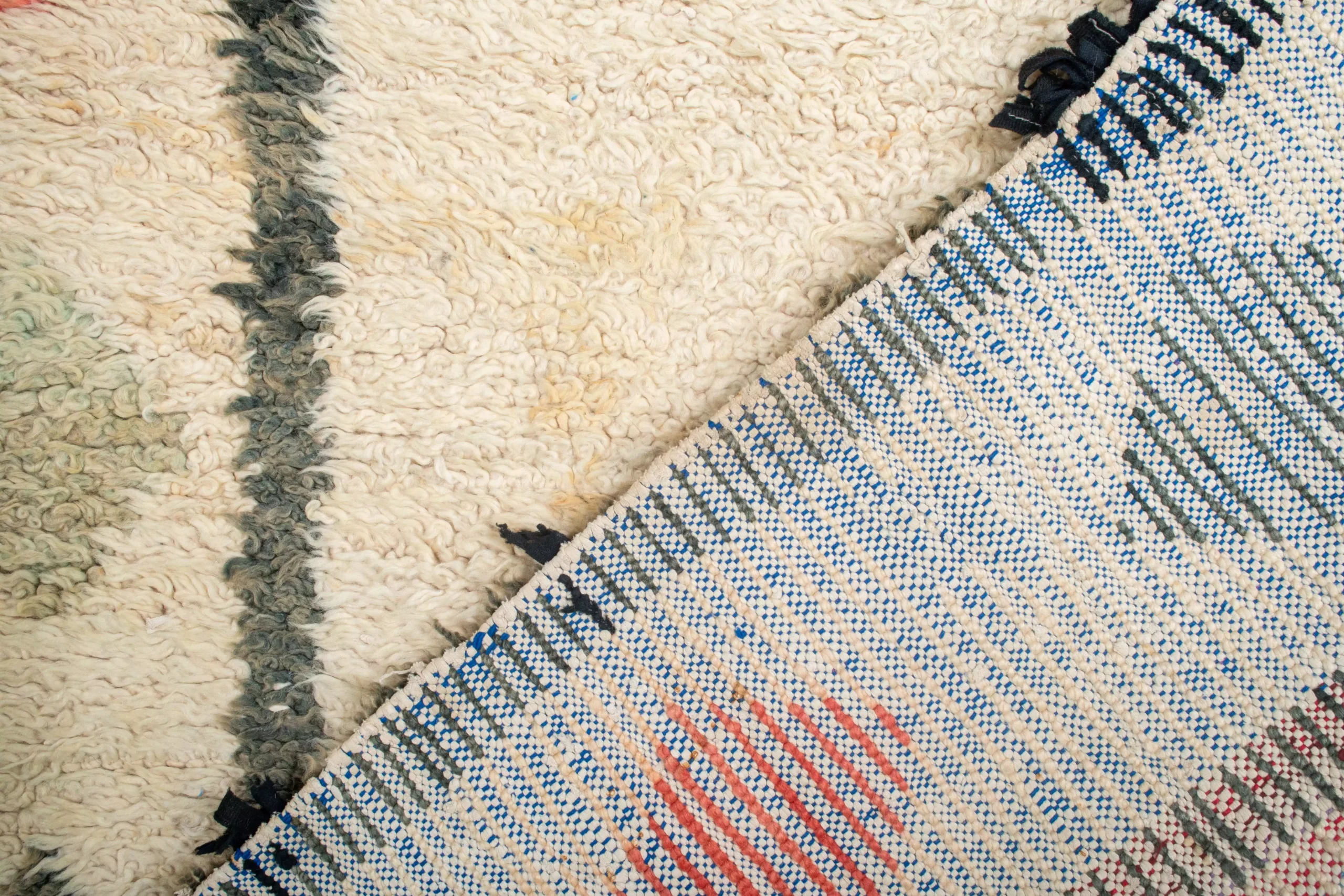 a pile of white and blue rugs. AZL-007_W-40_275-164 (9)