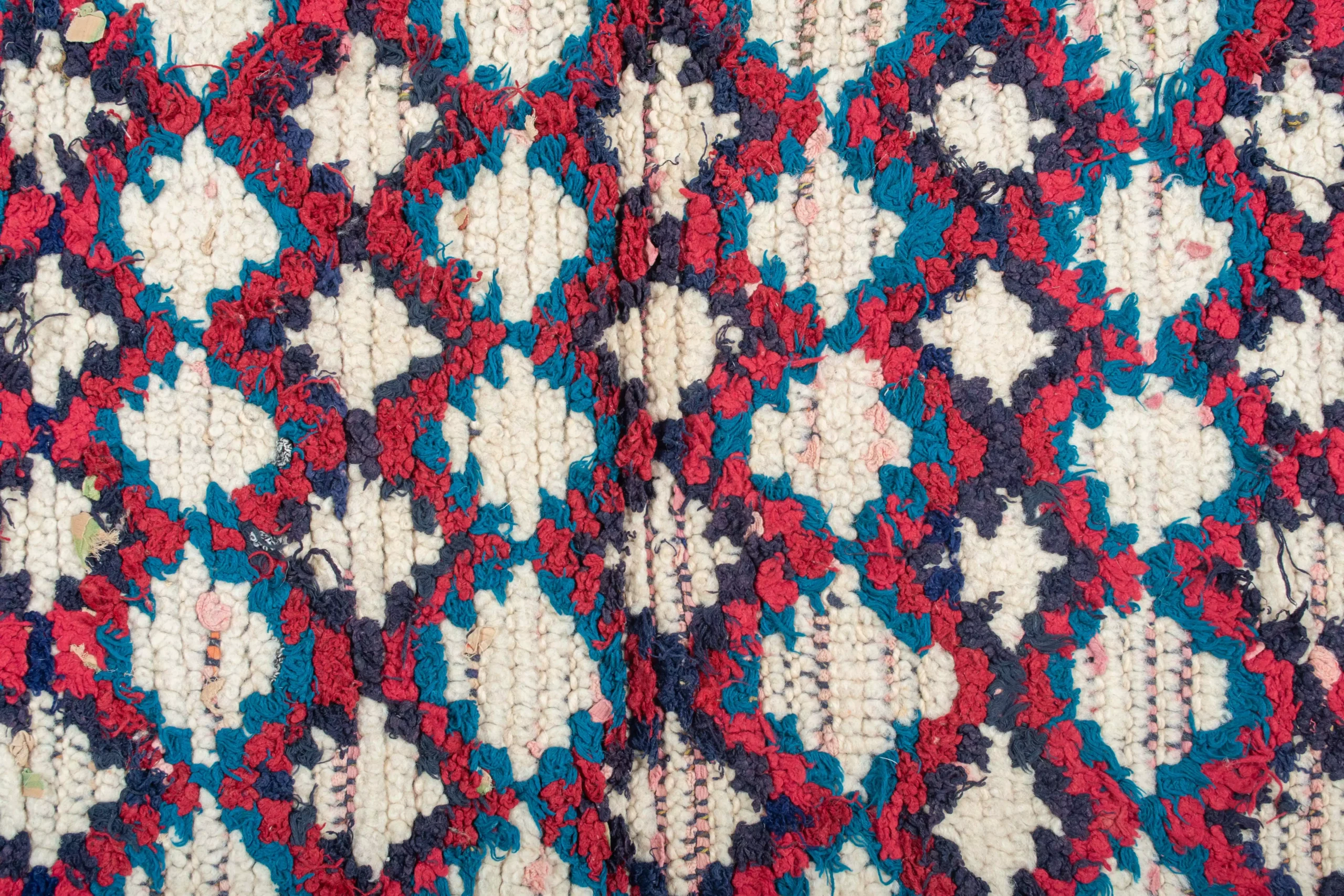 a close up of a red and blue floral print fabric. AZL-014_W-40_176-080 (5)
