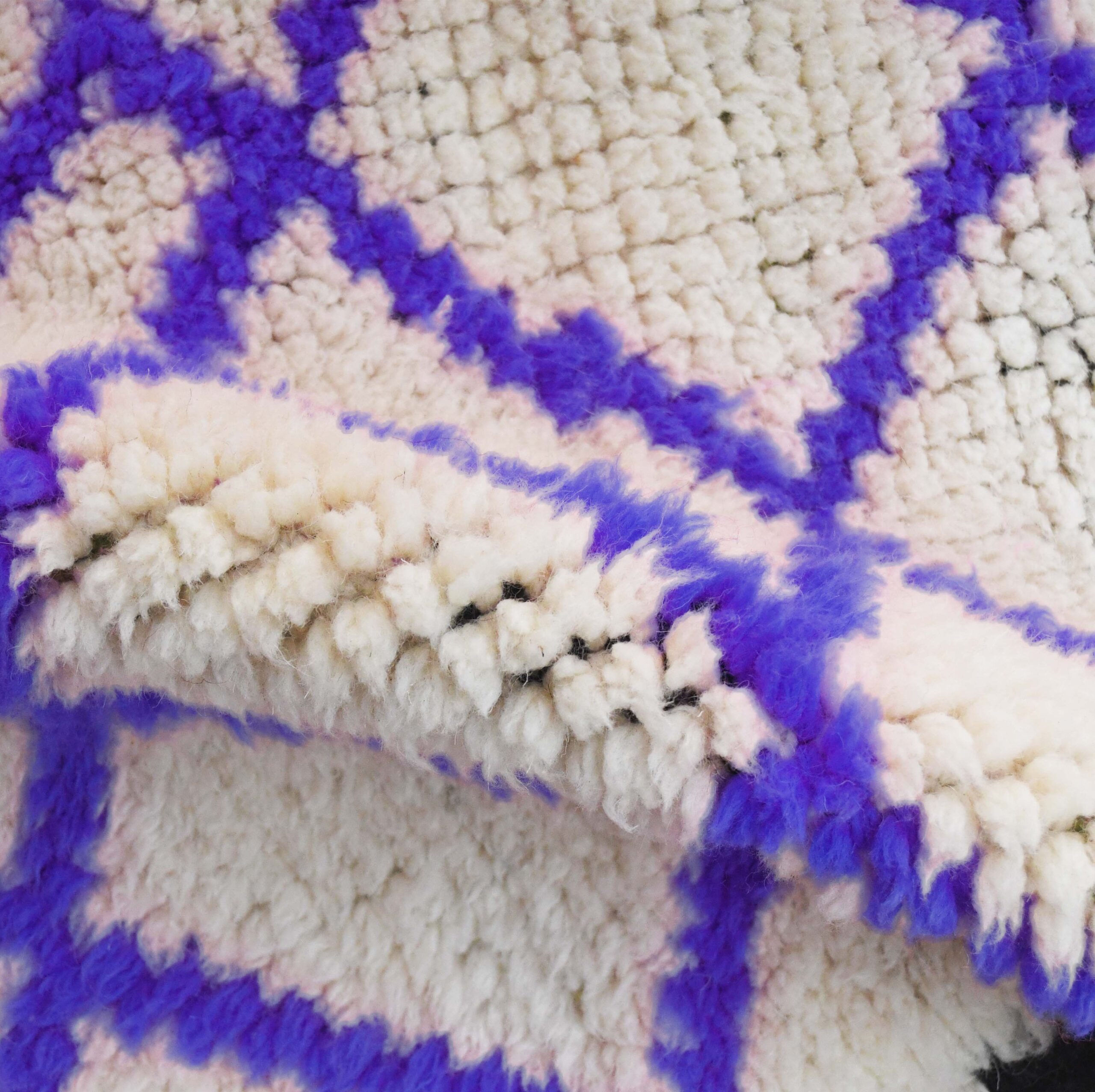 a sheep is laying on a moroccan rug. VIN311_W-40_PR-19_BK-39_GR-13_06