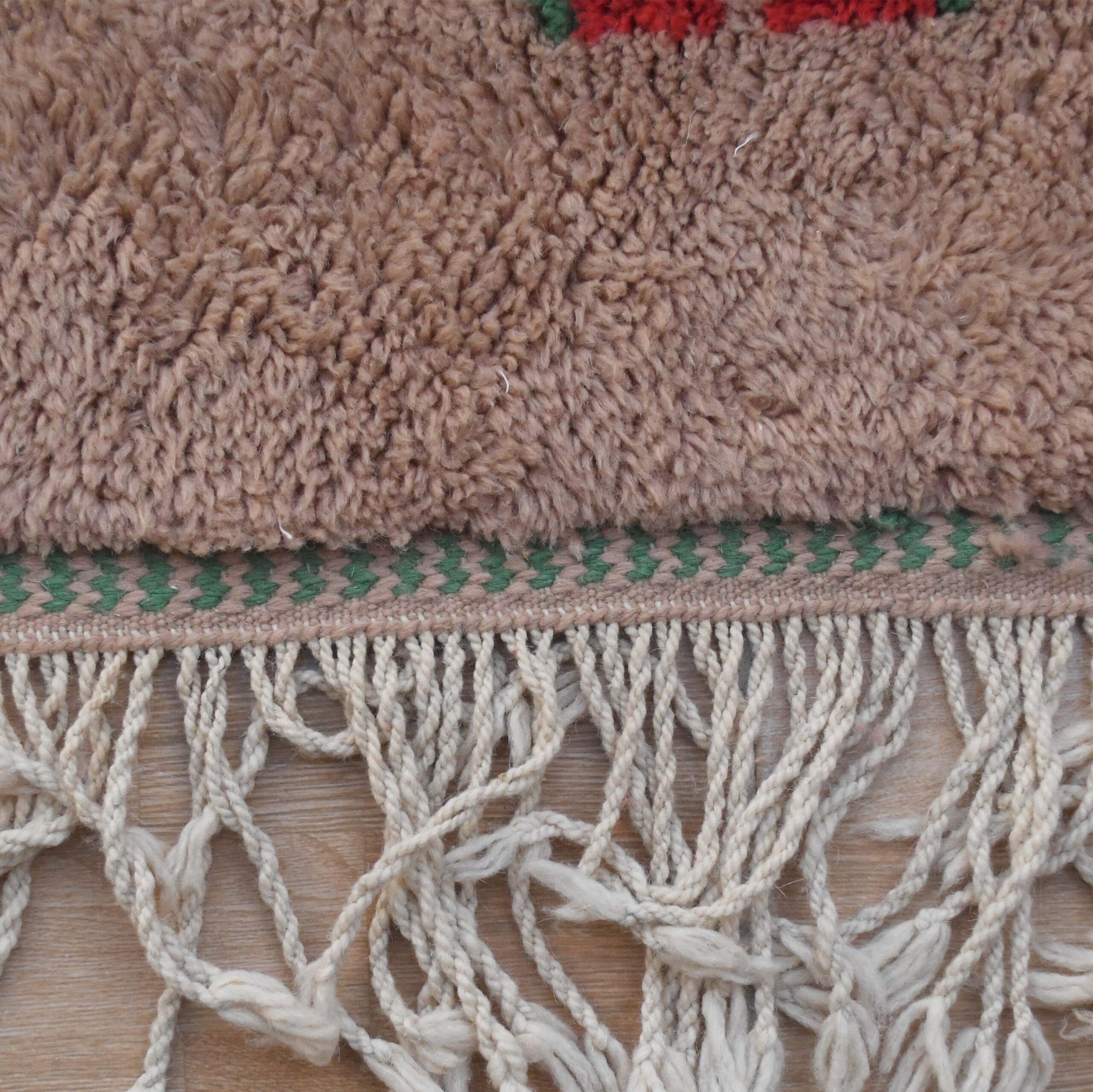 a close up of a rug with a red flower. VIN312_CR-01_GR2-97_GR-11_OR-24_PN-35_PN-33_BL-09_BR-302_BR-32_BR-28_PR-19_GY_37_BK-39_05