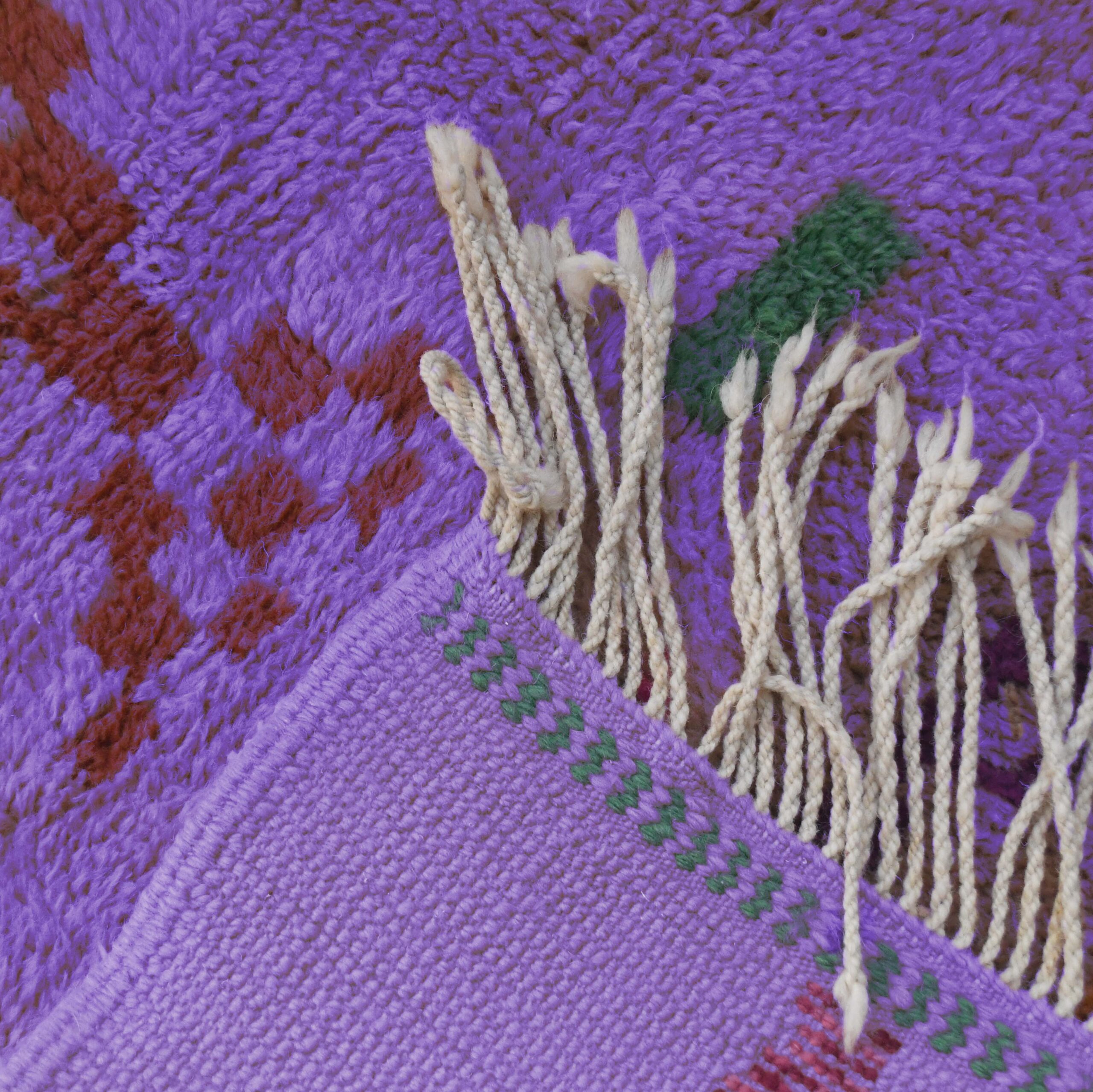 a purple and red moroccan rug with a green leaf. VIN312_PR-21_GR2-97_GR-11_OR-24_PN-35_PN-33_BL-09_BR-302_BR-32_BR-28_PR-19_GY_37_BK-39_06