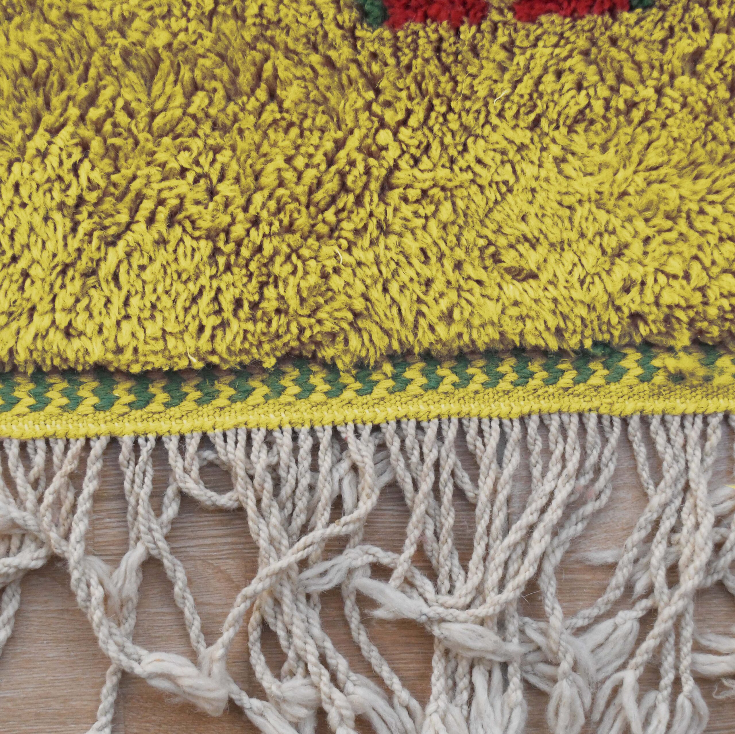 a close up of a yellow and green knitted moroccan rug. VIN312_YL-15_GR2-97_GR-11_OR-24_PN-35_PN-33_BL-09_BR-302_BR-32_BR-28_PR-19_GY_37_BK-39_05