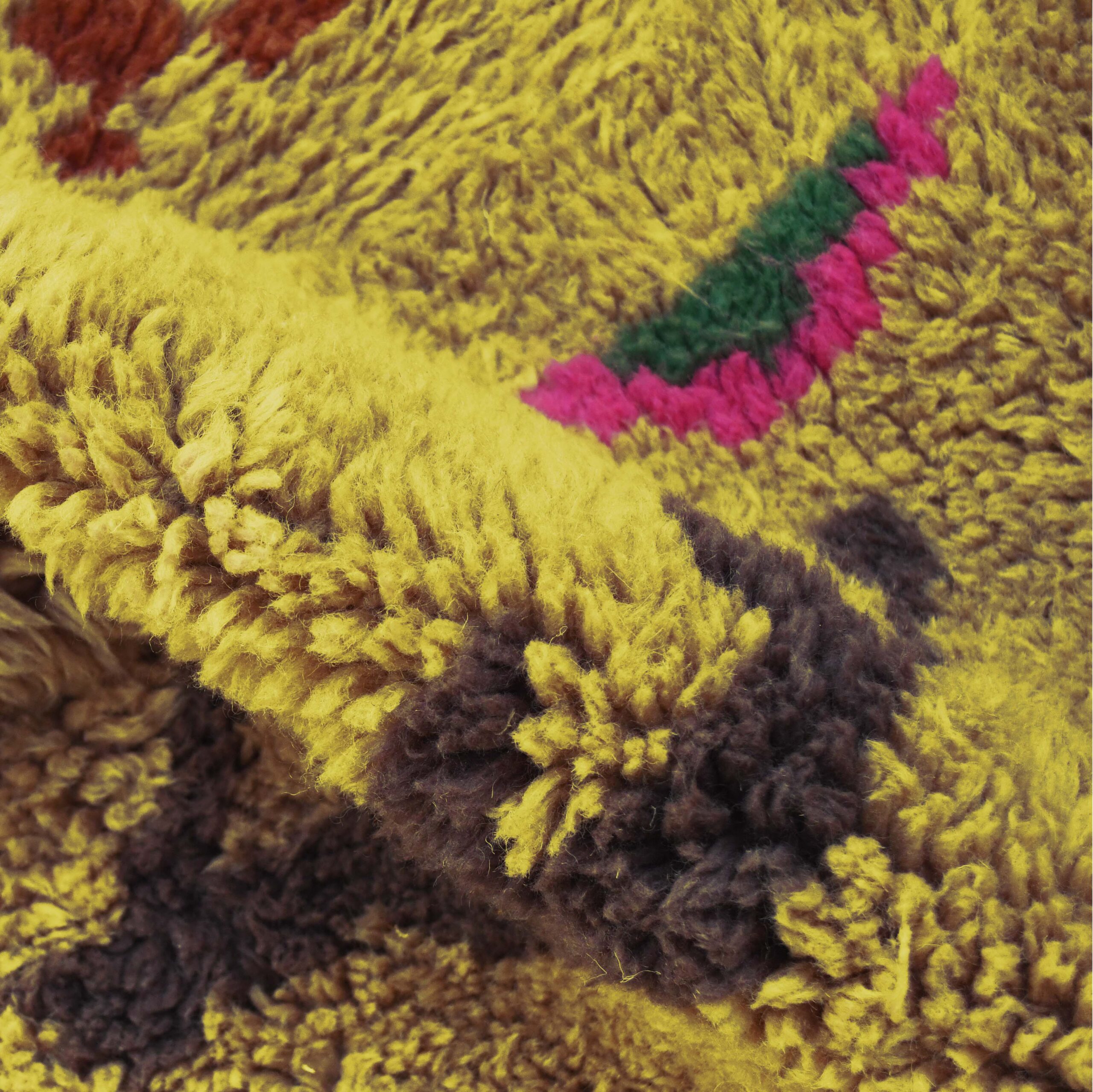 a close up of a teddy bear on a moroccan rug. VIN312_YL-15_GR2-97_GR-11_OR-24_PN-35_PN-33_BL-09_BR-302_BR-32_BR-28_PR-19_GY_37_BK-39_07