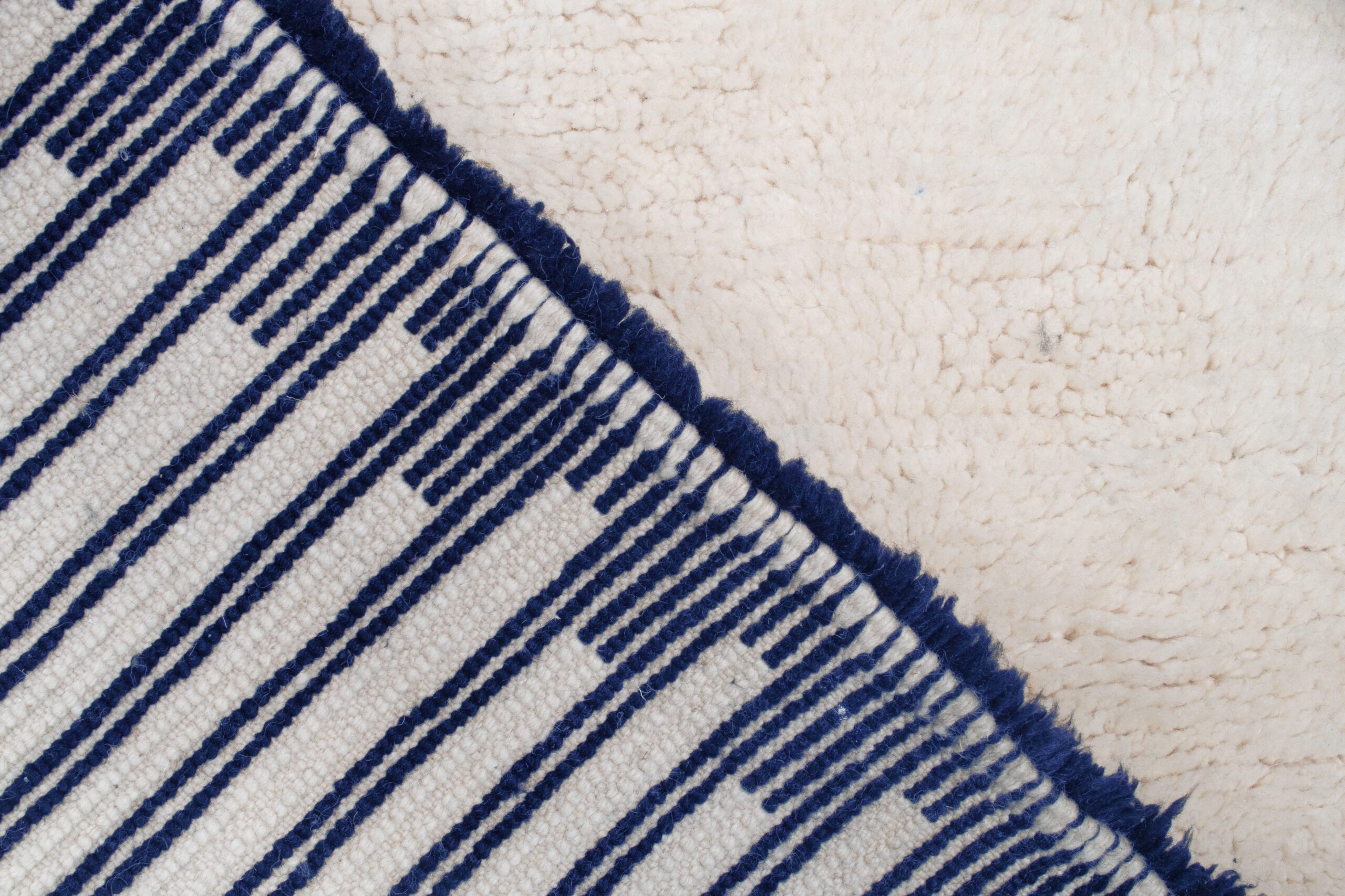 a close up of a moroccan rug with a blue and white stripe. VINA034-W-40_BL-01 (10)