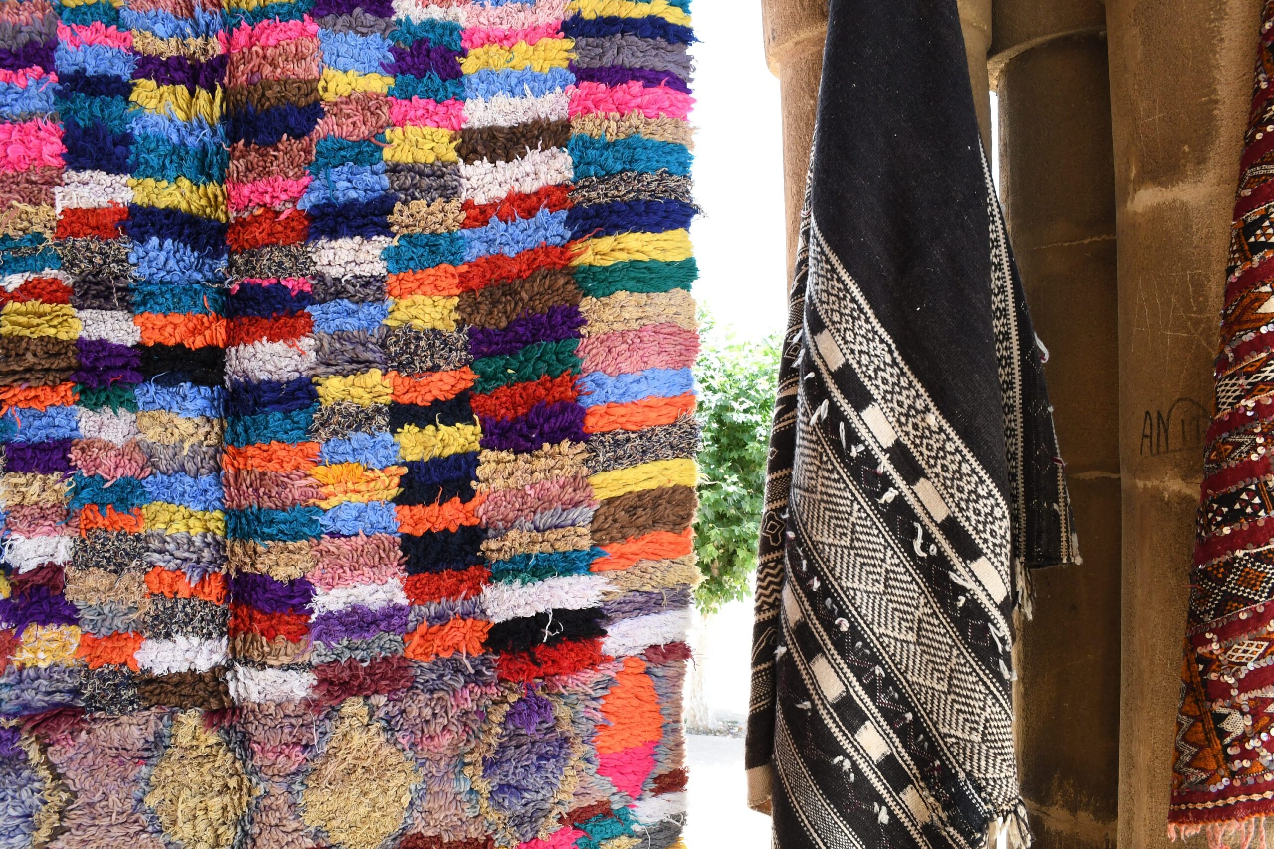 a pile of colorful rugs hanging on a wall. il_fullxfull.6017213472_miqe.jpg