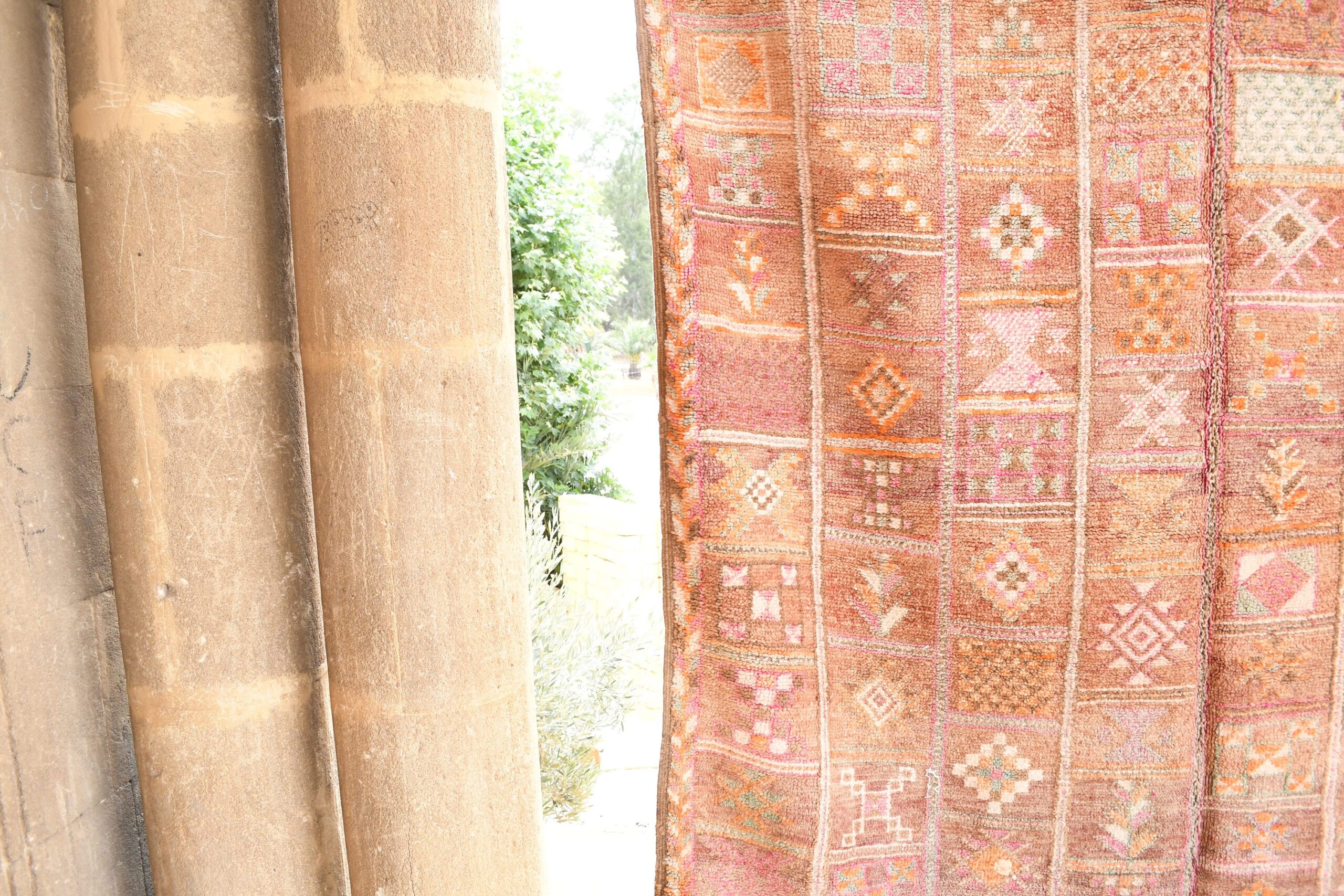 a pink and orange patterned curtain hanging on a wooden pole. il_fullxfull.6017466332_2i2d.jpg