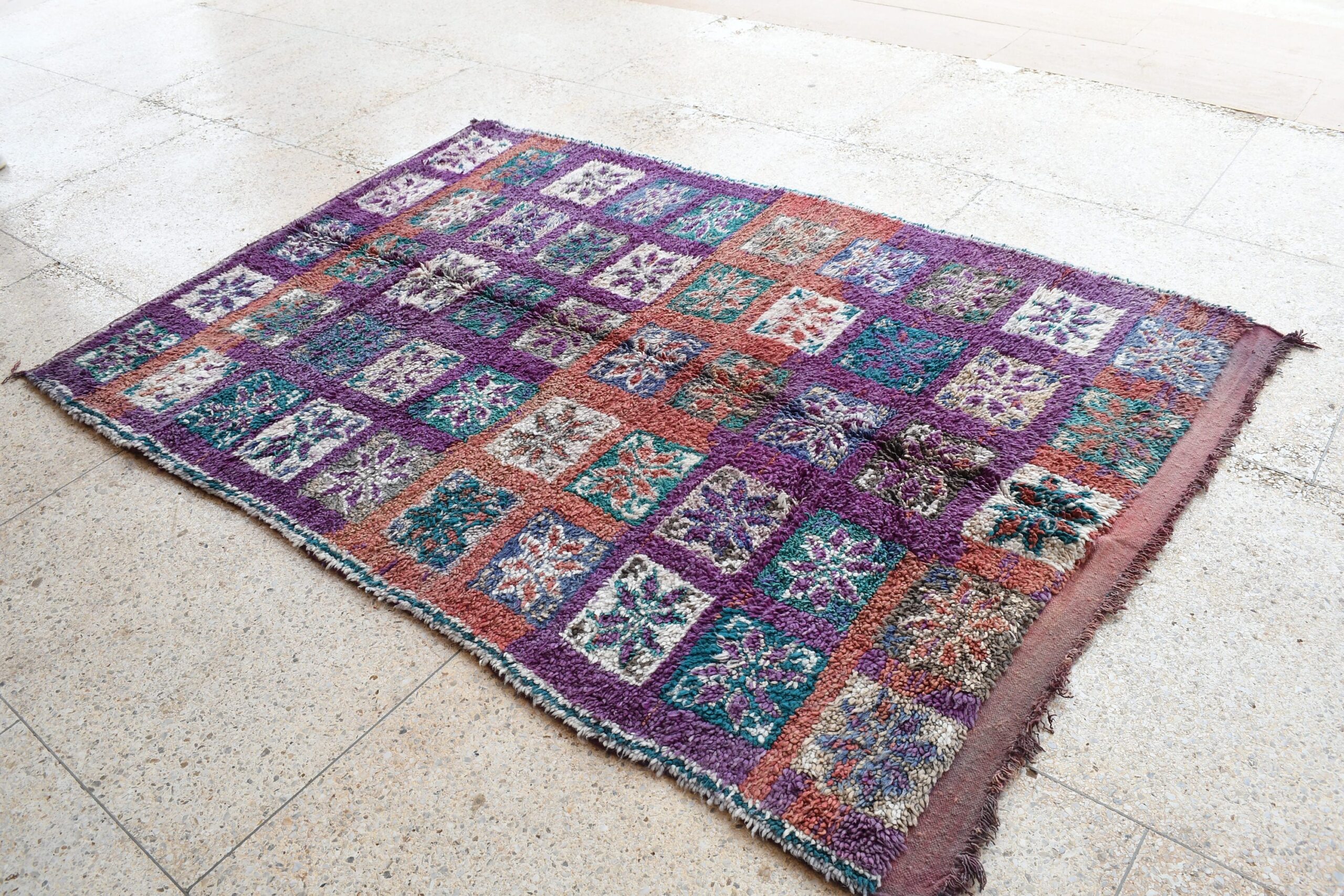 a purple and blue rug with a patchwork pattern. il_fullxfull.6017487454_draz.jpg