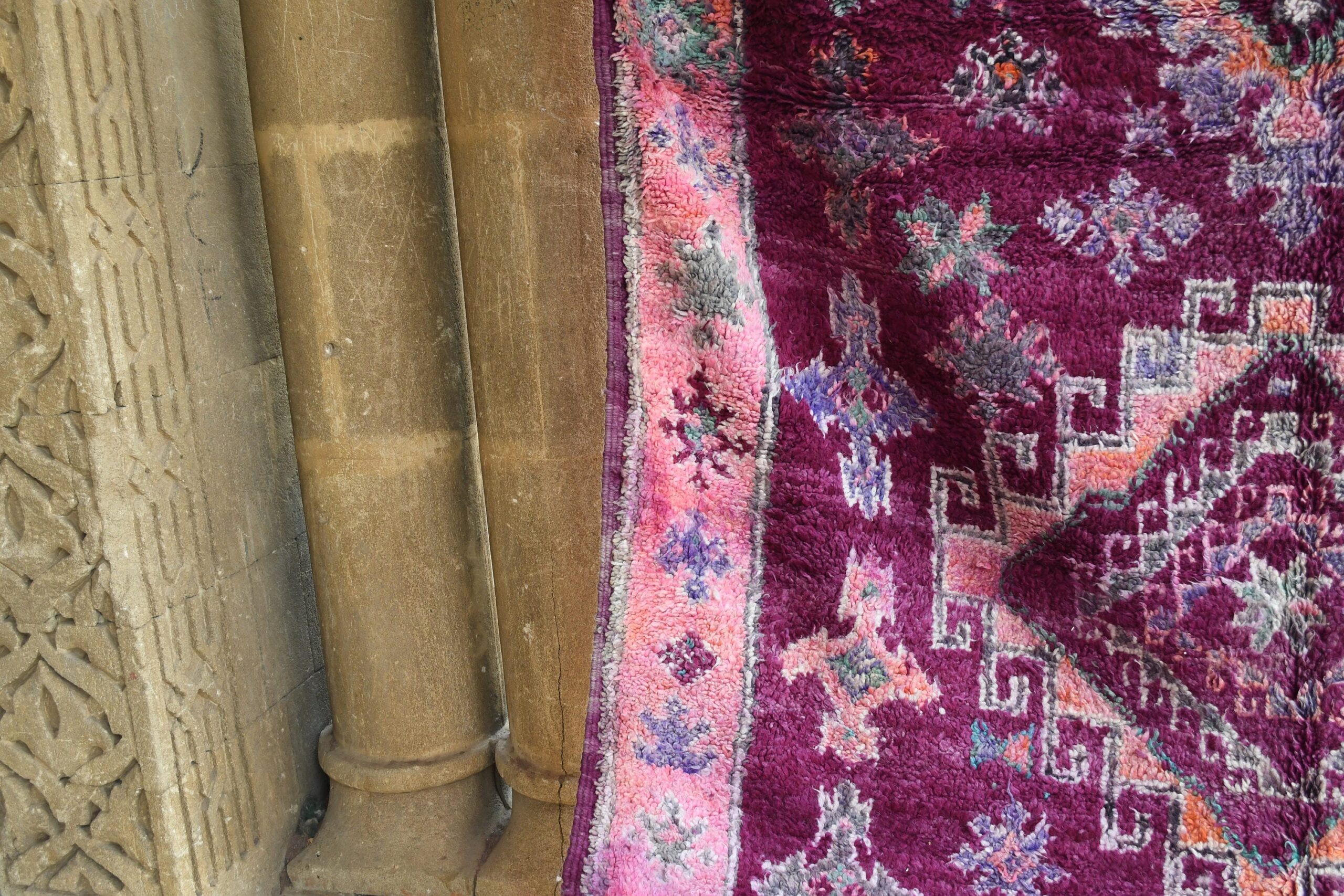 a purple rug with a pink and purple design. il_fullxfull.6017504742_39jl.jpg