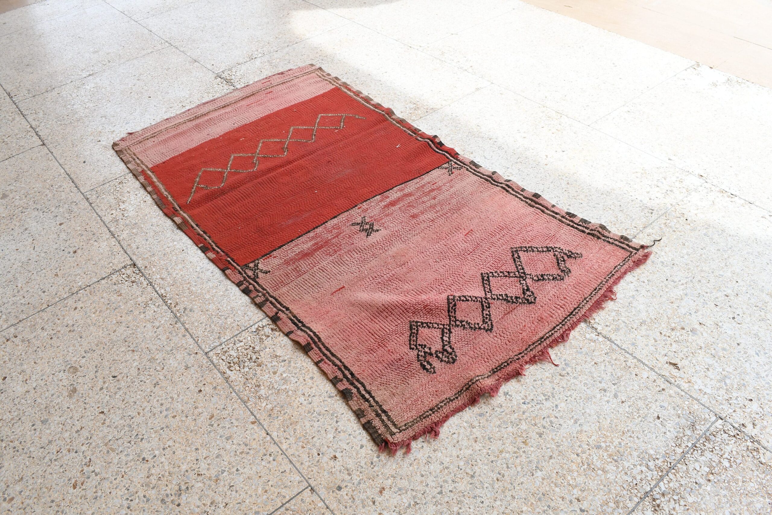 a red rug with a black and white design. il_fullxfull.6017514572_2n51.jpg