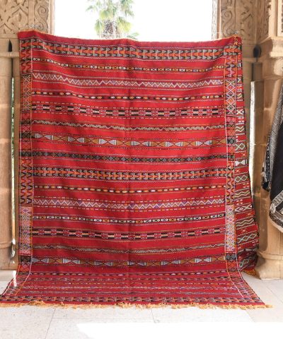 a red and black rug hanging on a wall. il_fullxfull.6017575796_eift.jpg