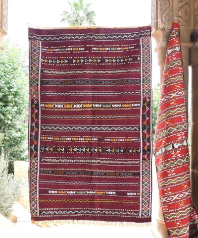 a red and black rug hanging on a wall. il_fullxfull.6017579320_cxib.jpg