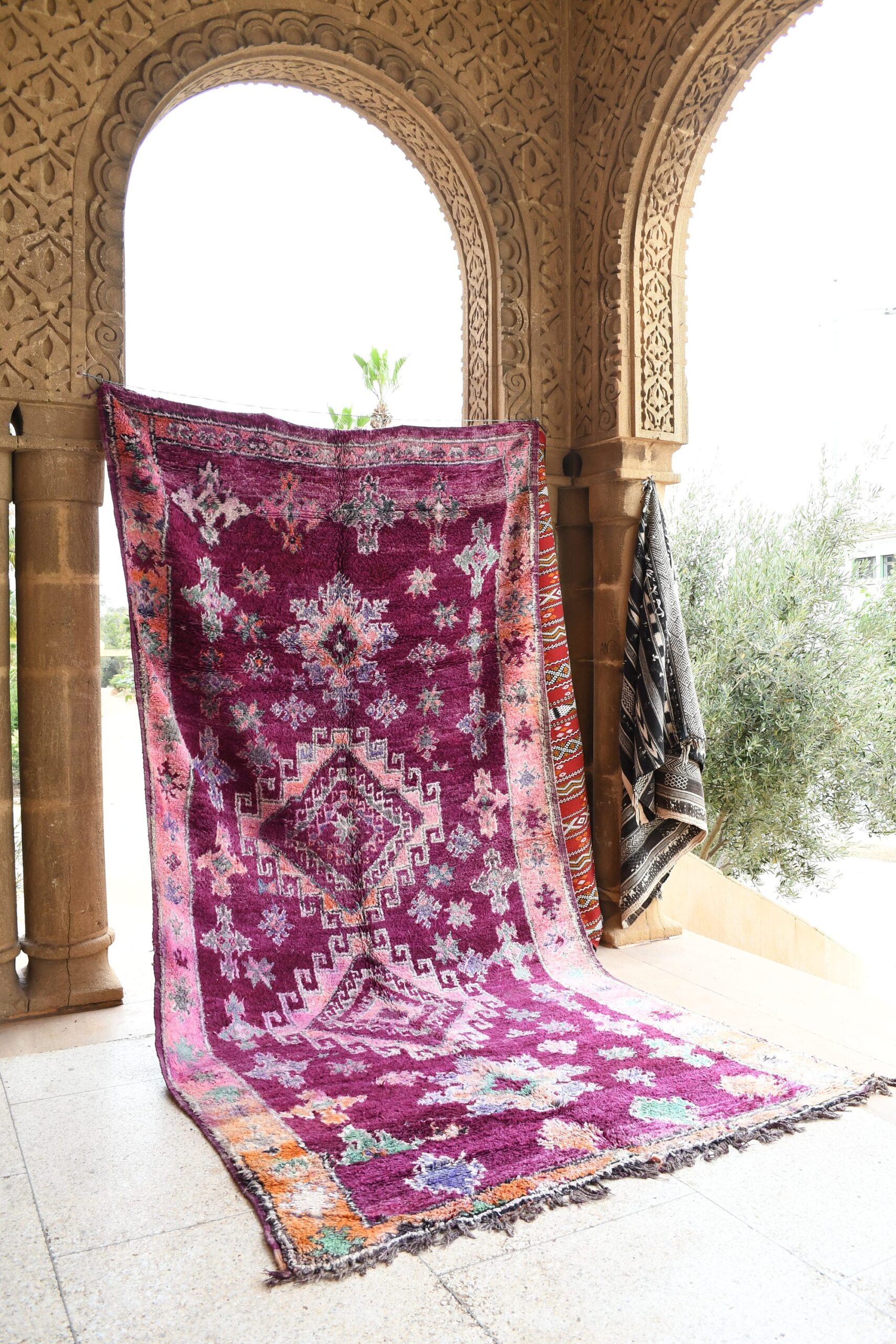 a purple and pink rug on a porch. il_fullxfull.6021319312_2lmn.jpg