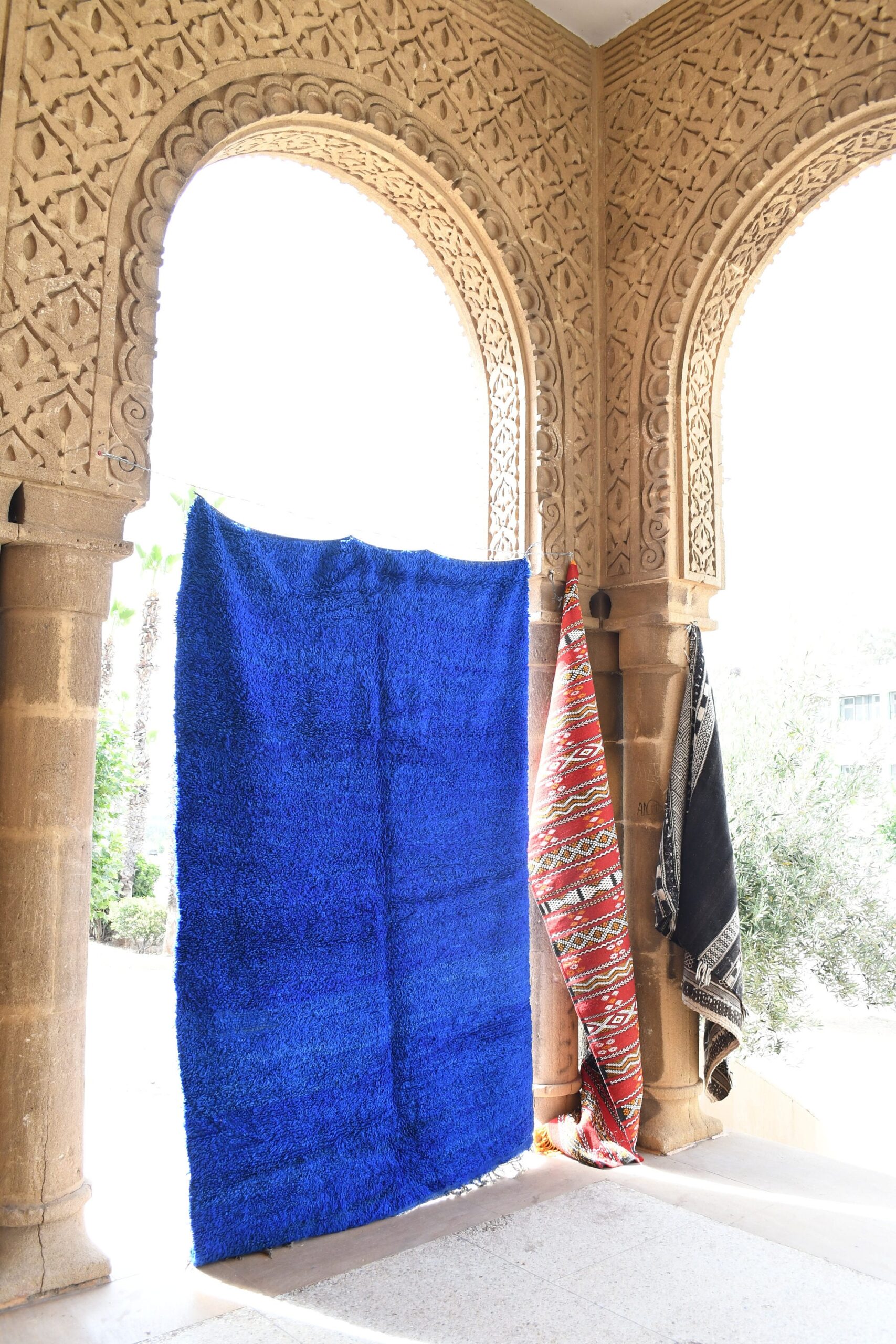 a blue rug is hanging on a wall. il_fullxfull.6021349536_f3l3.jpg