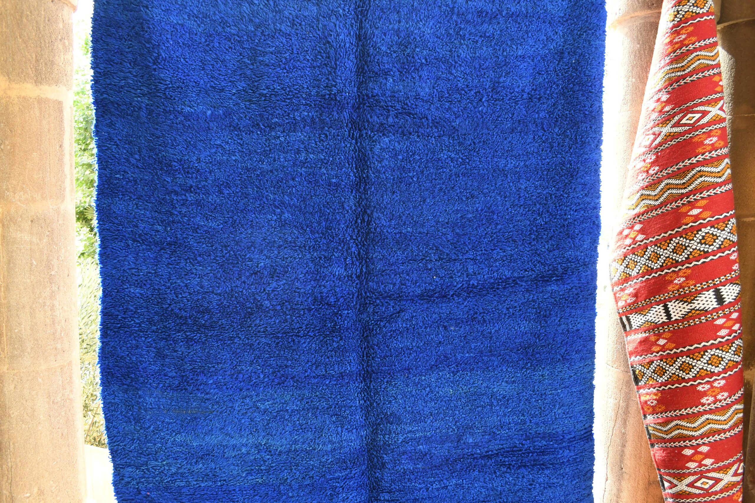 a blue rug hanging on a wall. il_fullxfull.6021349546_4f1d.jpg