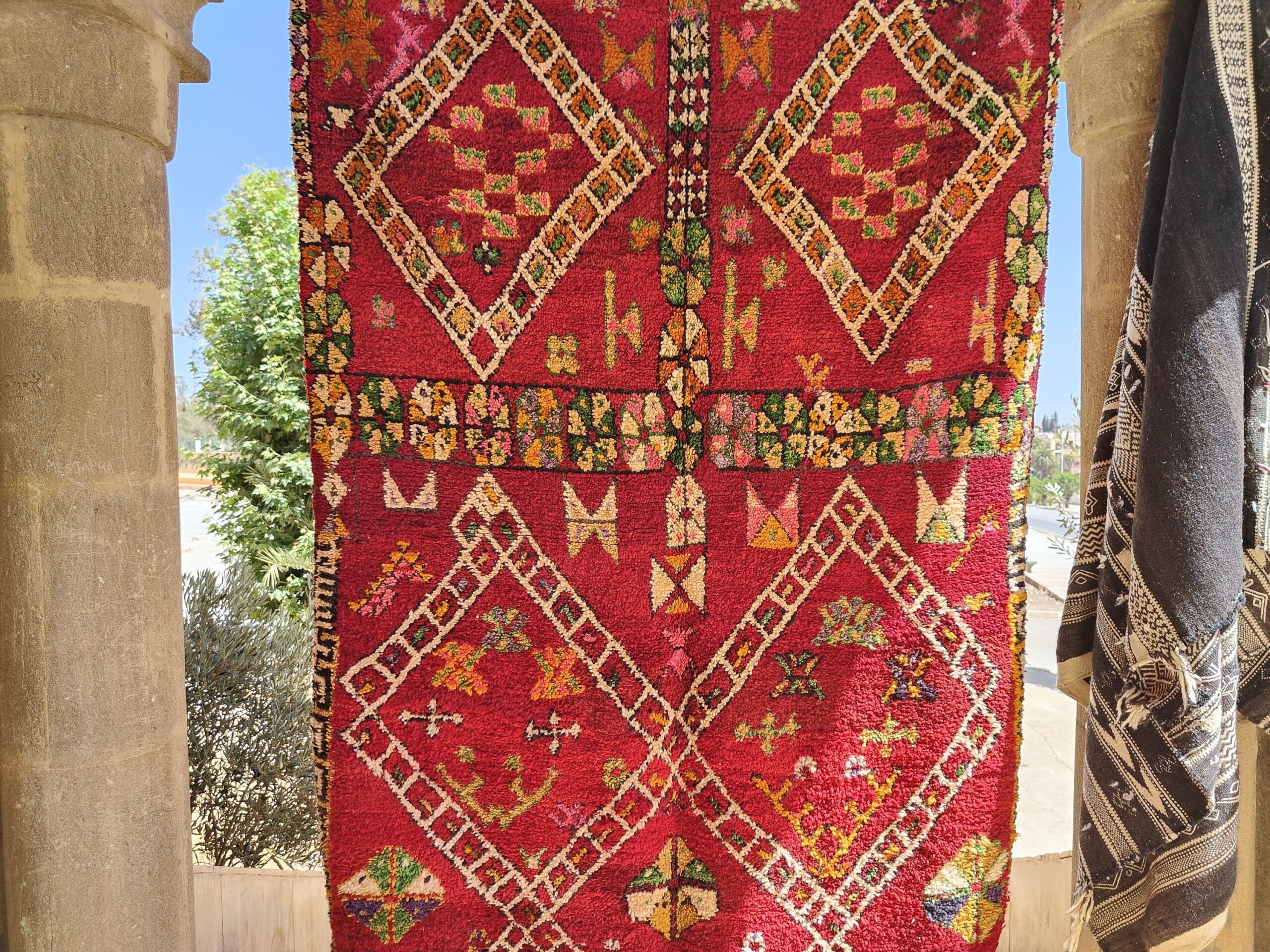 a red rug hanging on a wall. il_fullxfull.6023099770_76av.jpg