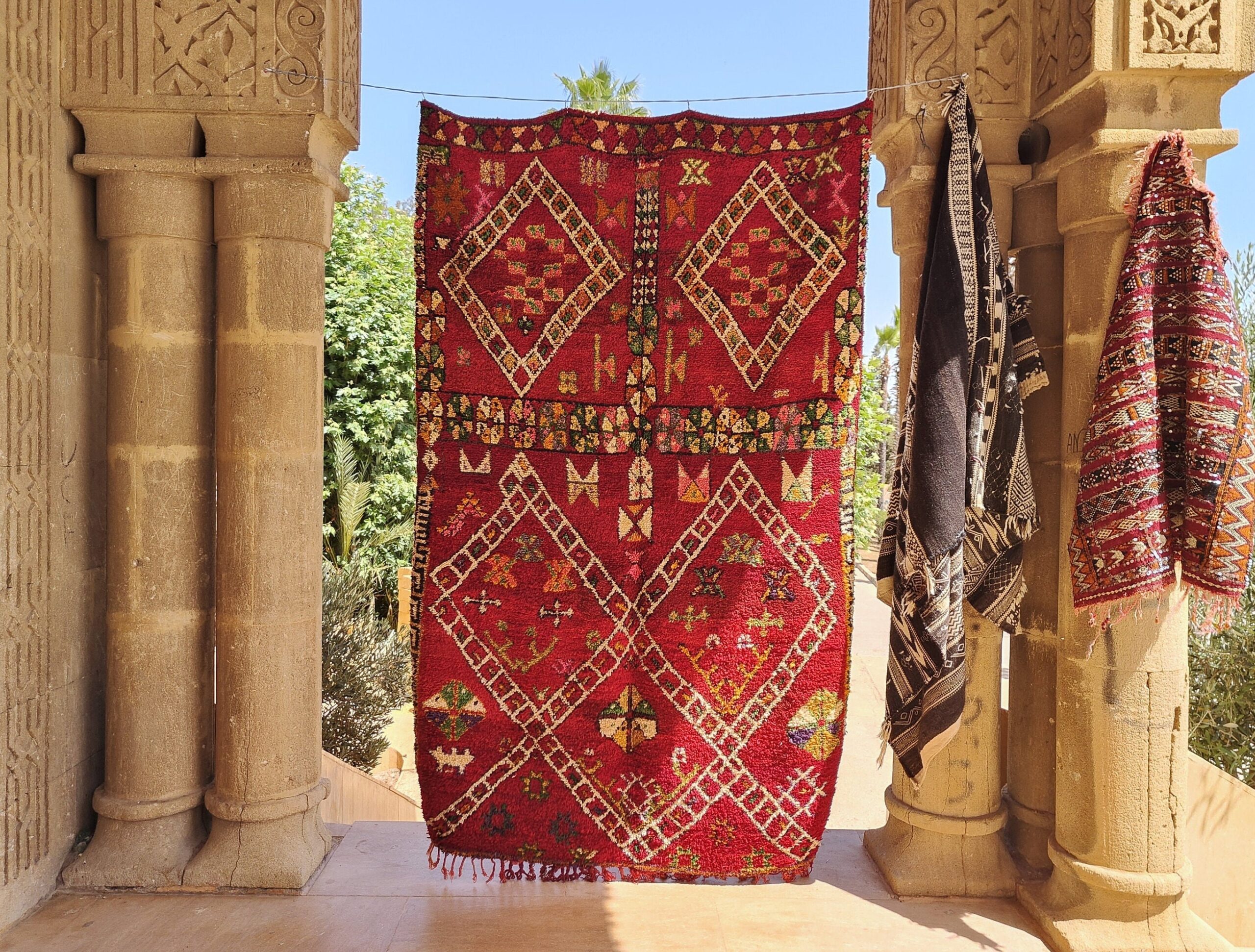 a red rug hanging on a wall. il_fullxfull.6023101332_2ryv.jpg