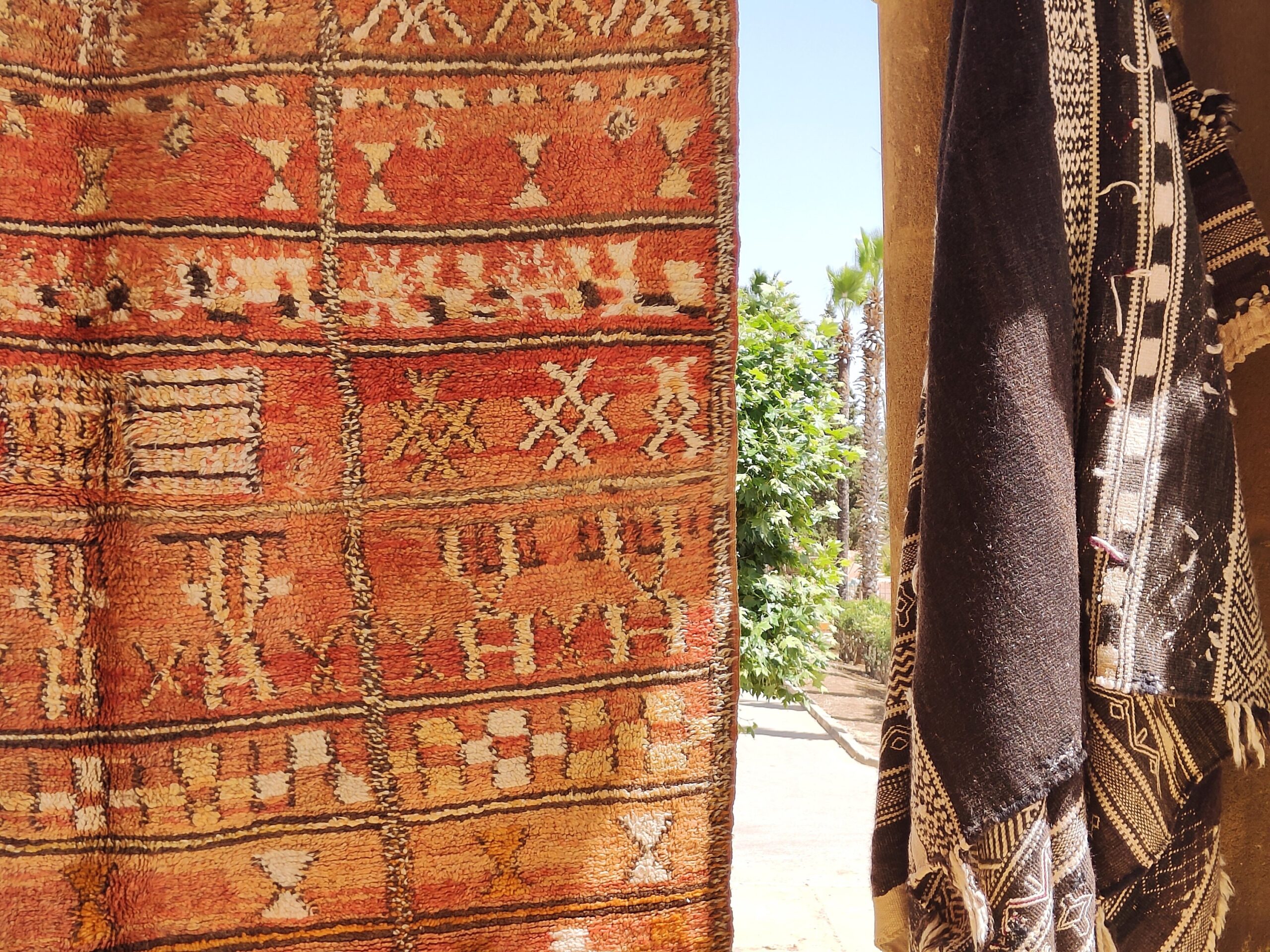a red rug hanging on a wall. il_fullxfull.6023111330_4r7l.jpg