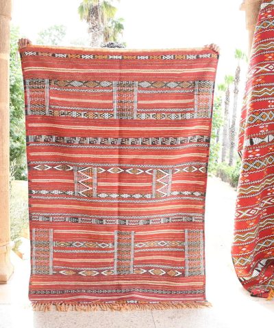 a red and white moroccan rug hanging on a wall. il_fullxfull.6025853490_hmfj.jpg