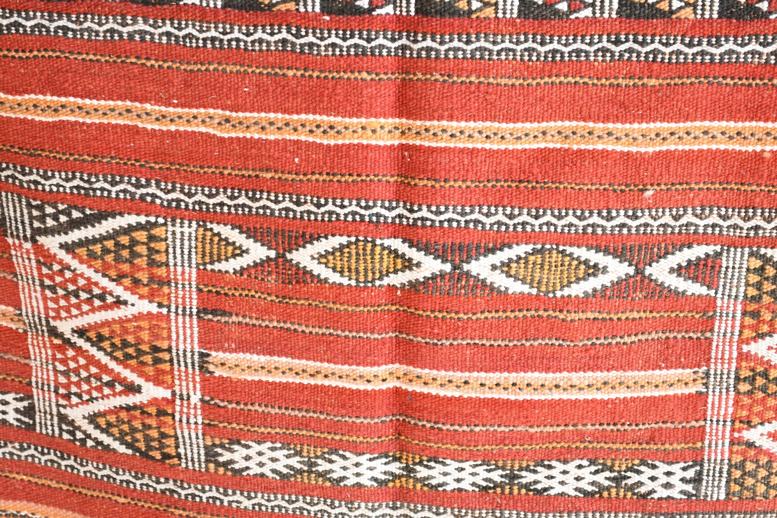 a red and black patterned rug with a pattern. il_fullxfull.6025853638_qoie.jpg