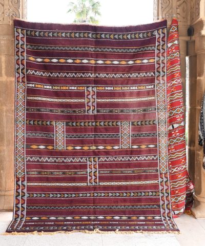 a large red and black rug hanging on a wall. il_fullxfull.6025854806_3go2.jpg