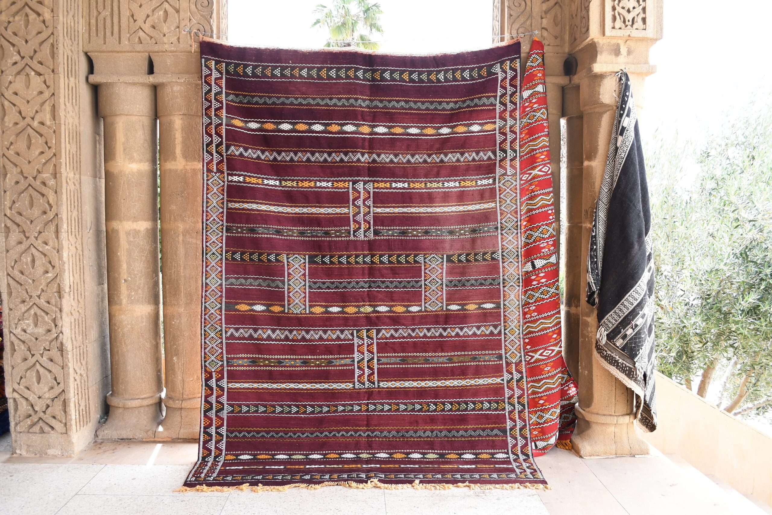 a large red and black rug hanging on a wall. il_fullxfull.6025854806_3go2.jpg