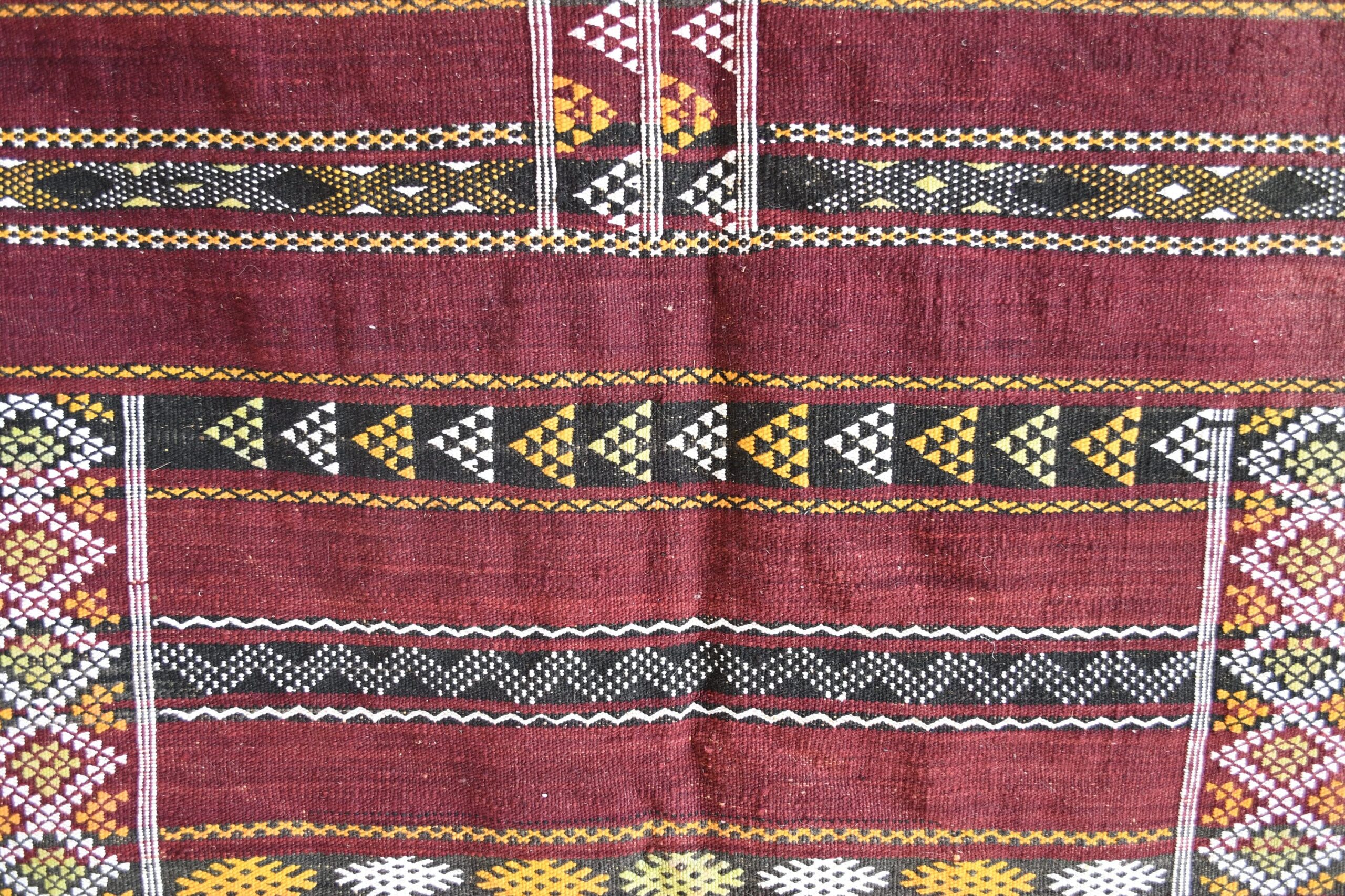 a red and black rug with geometric patterns. il_fullxfull.6025854938_1bb7.jpg