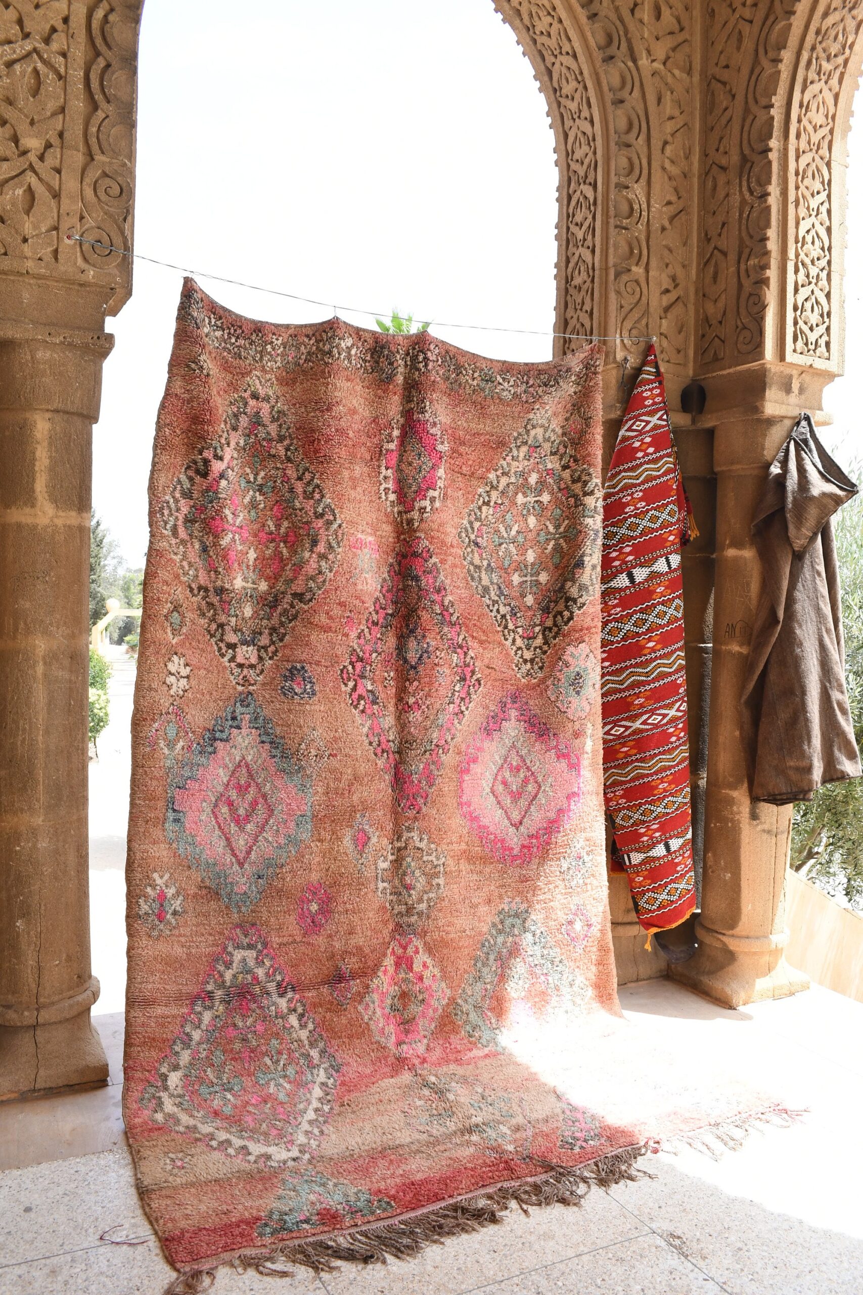 a rug hanging on a wall in a building. il_fullxfull.6025871408_cm02.jpg