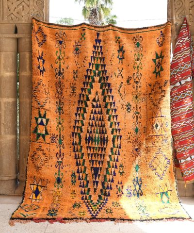 a large orange moroccan rug. il_fullxfull.6025885466_iw2o.jpg