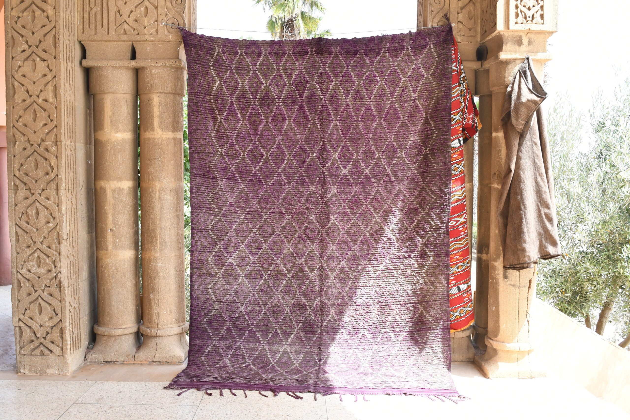 a purple rug hanging on a wall. il_fullxfull.6025889364_2bmi.jpg