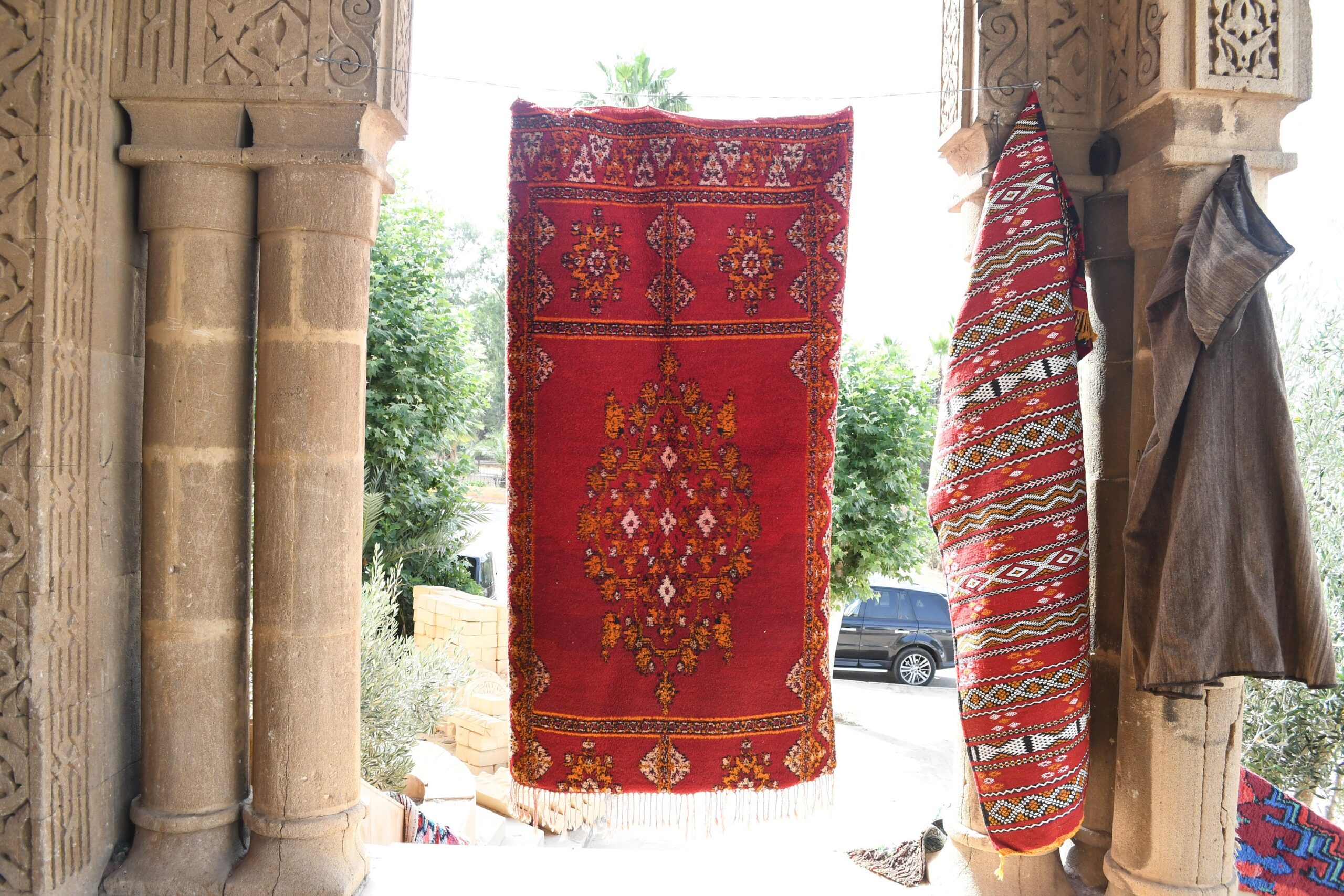 a red rug hanging on a wall. il_fullxfull.6028058676_1h1x.jpg
