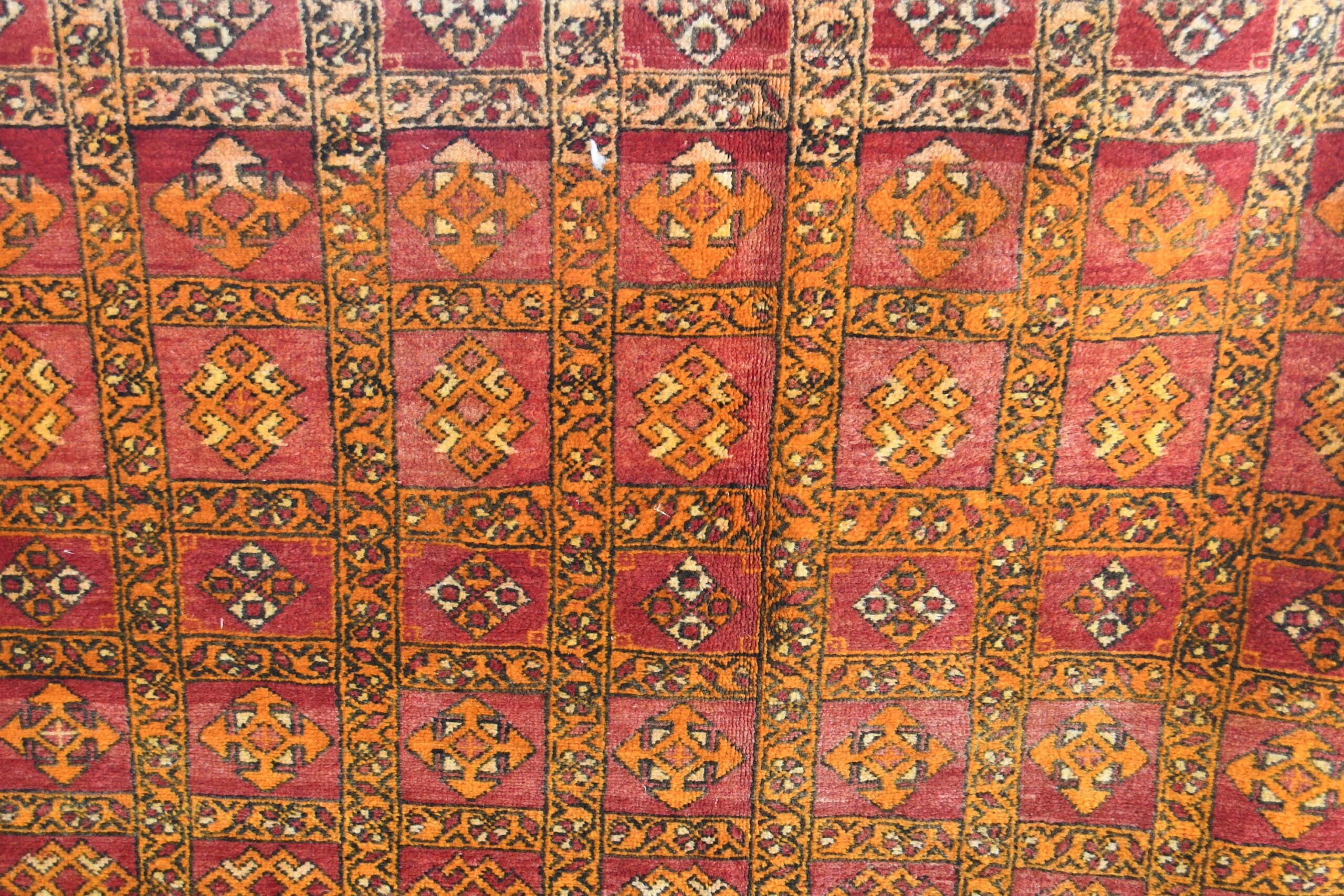 a red and yellow rug with a pattern of squares. il_fullxfull.6028066894_9vnp.jpg
