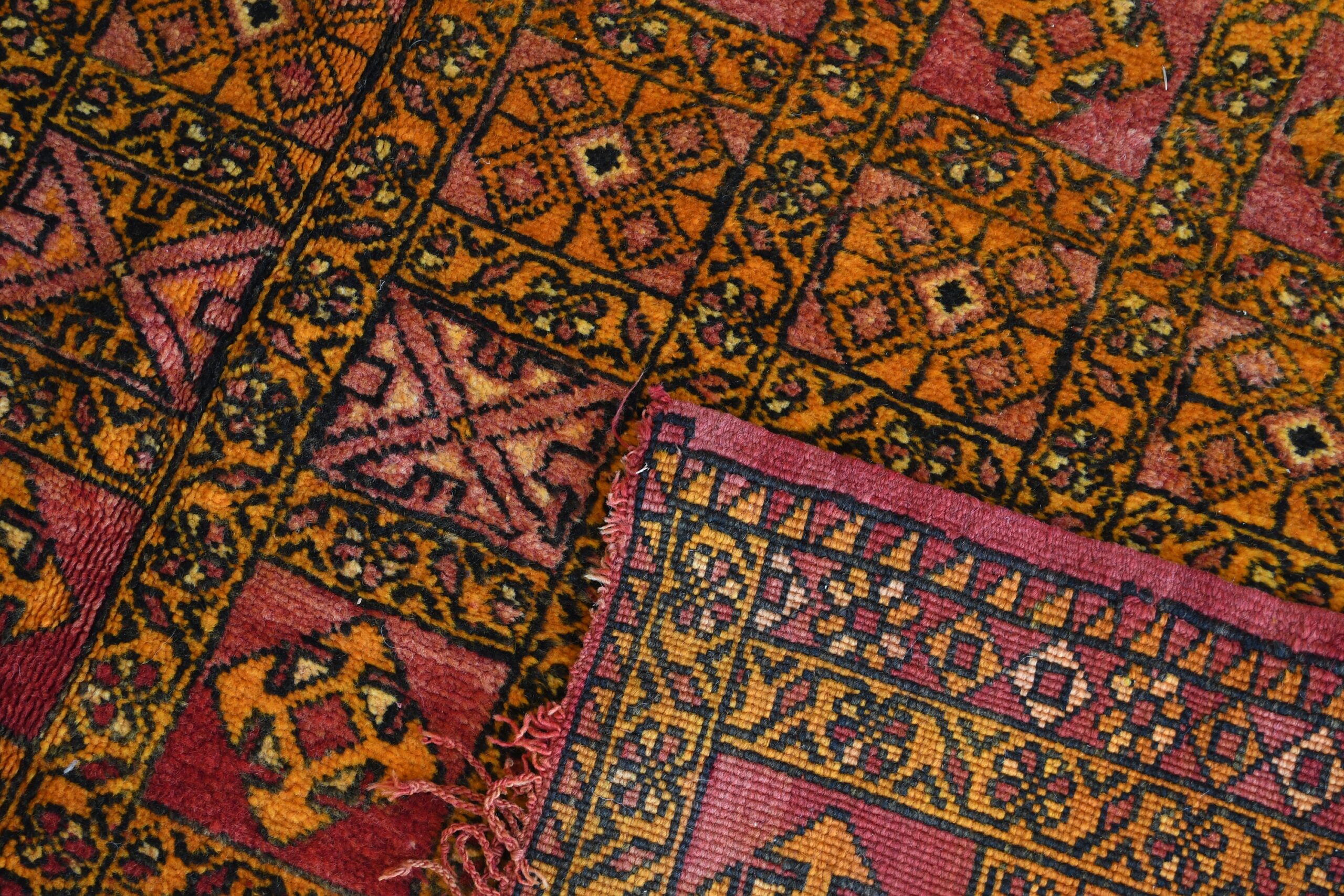 a rug with a red and yellow design. il_fullxfull.6028067648_6rxz.jpg