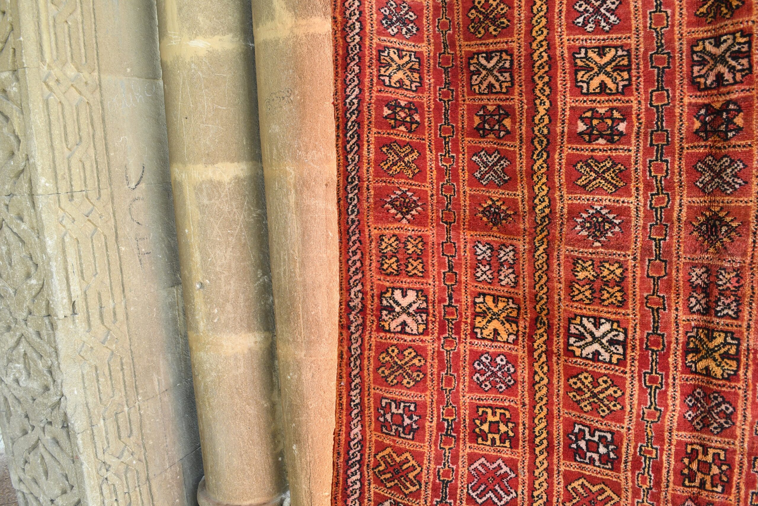 a red rug on a stone floor. il_fullxfull.6028068616_i6o3.jpg