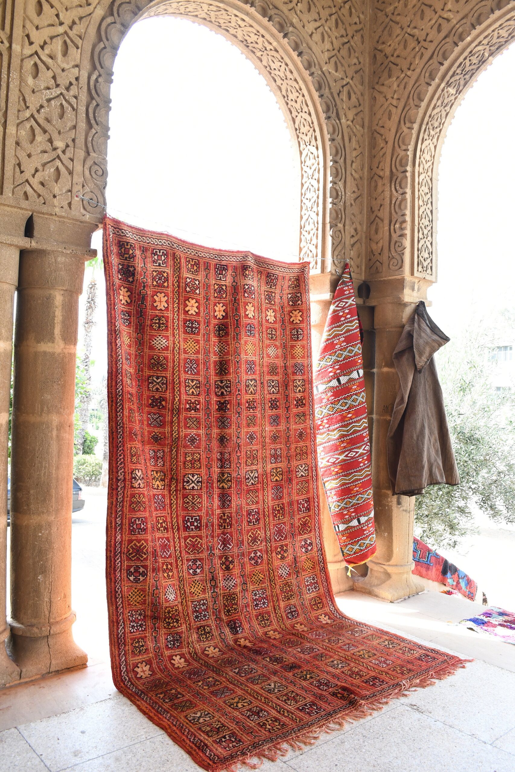 a red rug is hanging on a wall. il_fullxfull.6028068892_booq.jpg