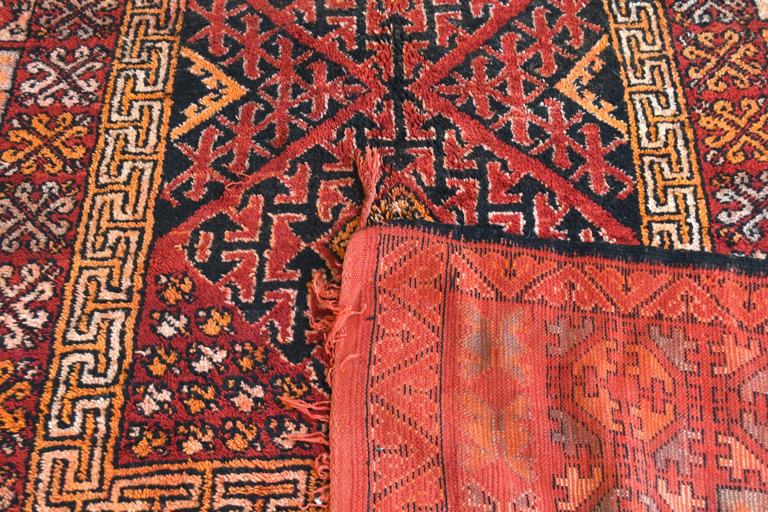 a rug with a red and black pattern. il_fullxfull.6028075266_btd3.jpg