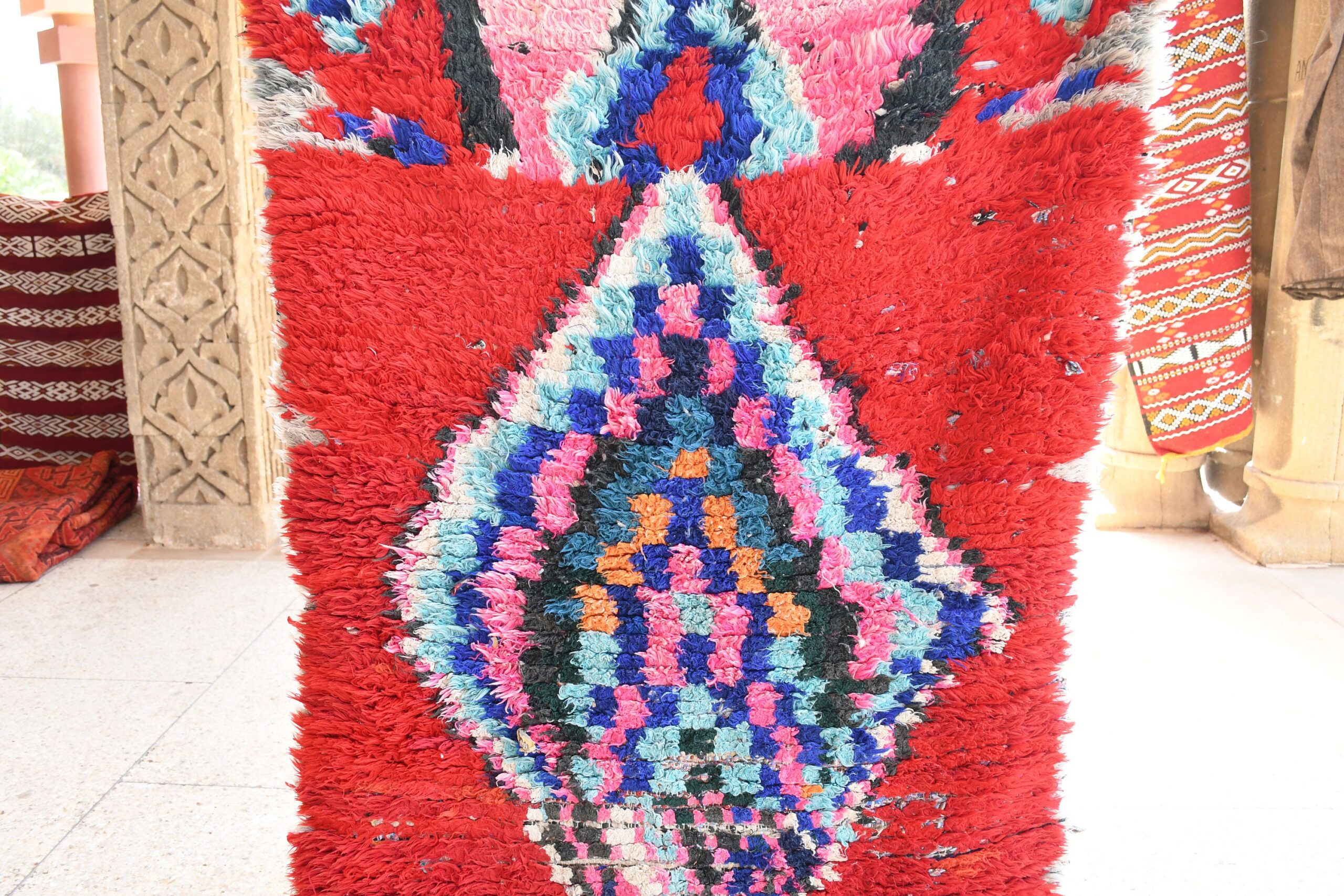a red rug with a pattern of flowers. il_fullxfull.6028102834_8qic.jpg