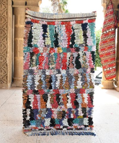 a colorful rug is hanging on a wall. il_fullxfull.6028104768_m0nd.jpg