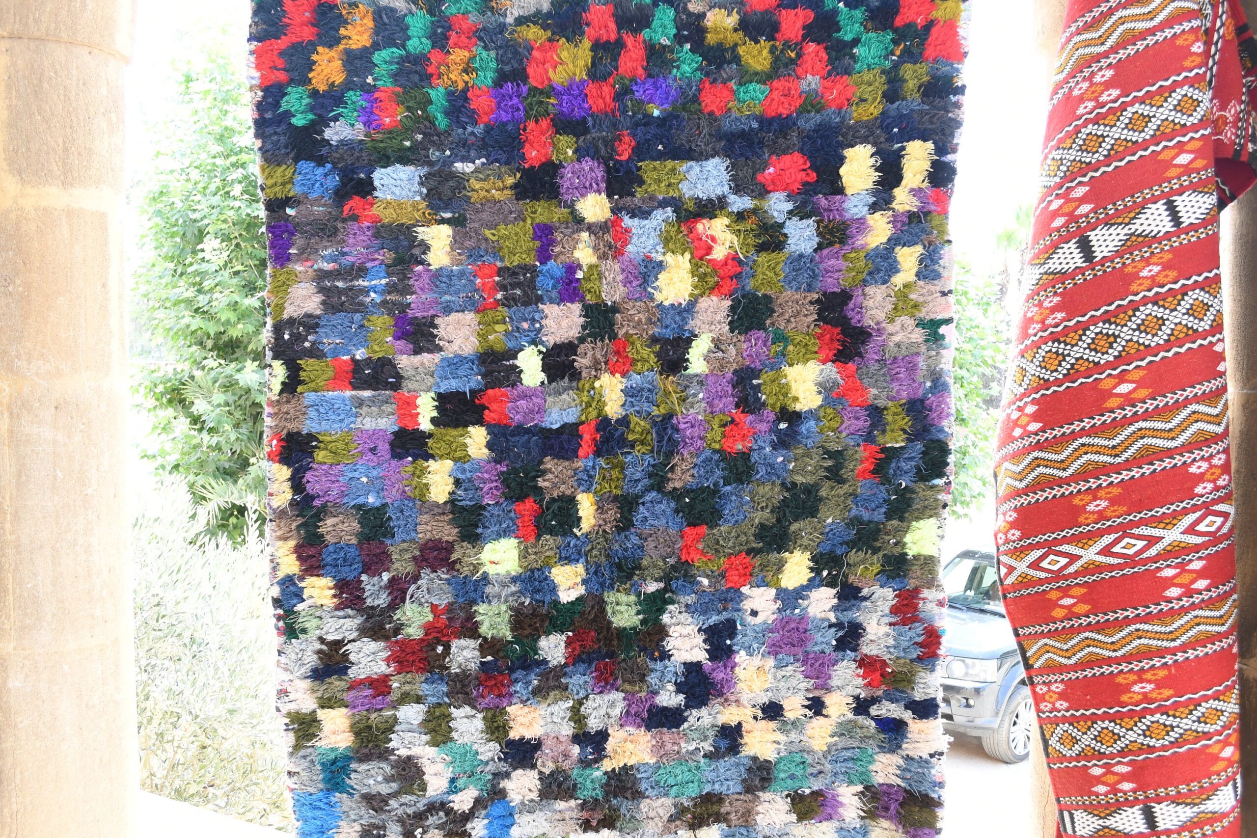 a colorful rug hanging on a wall. il_fullxfull.6028122462_o0x2.jpg