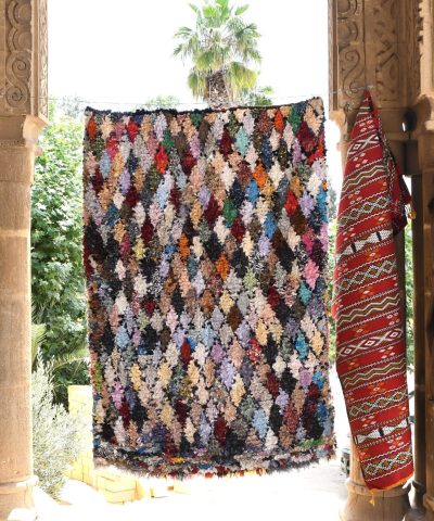 a colorful rug hanging from a stone archway. il_fullxfull.6028216414_g0xx.jpg