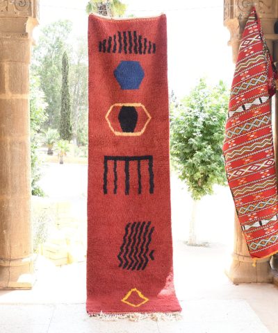 a red rug with a blue and yellow design. il_fullxfull.6028221132_u56f.jpg