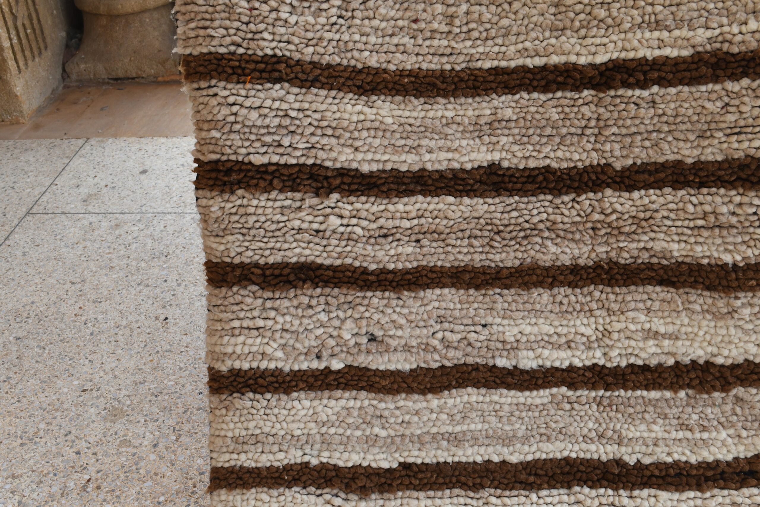 a rug with a brown and white stripe pattern. il_fullxfull.6028228082_m1a4.jpg