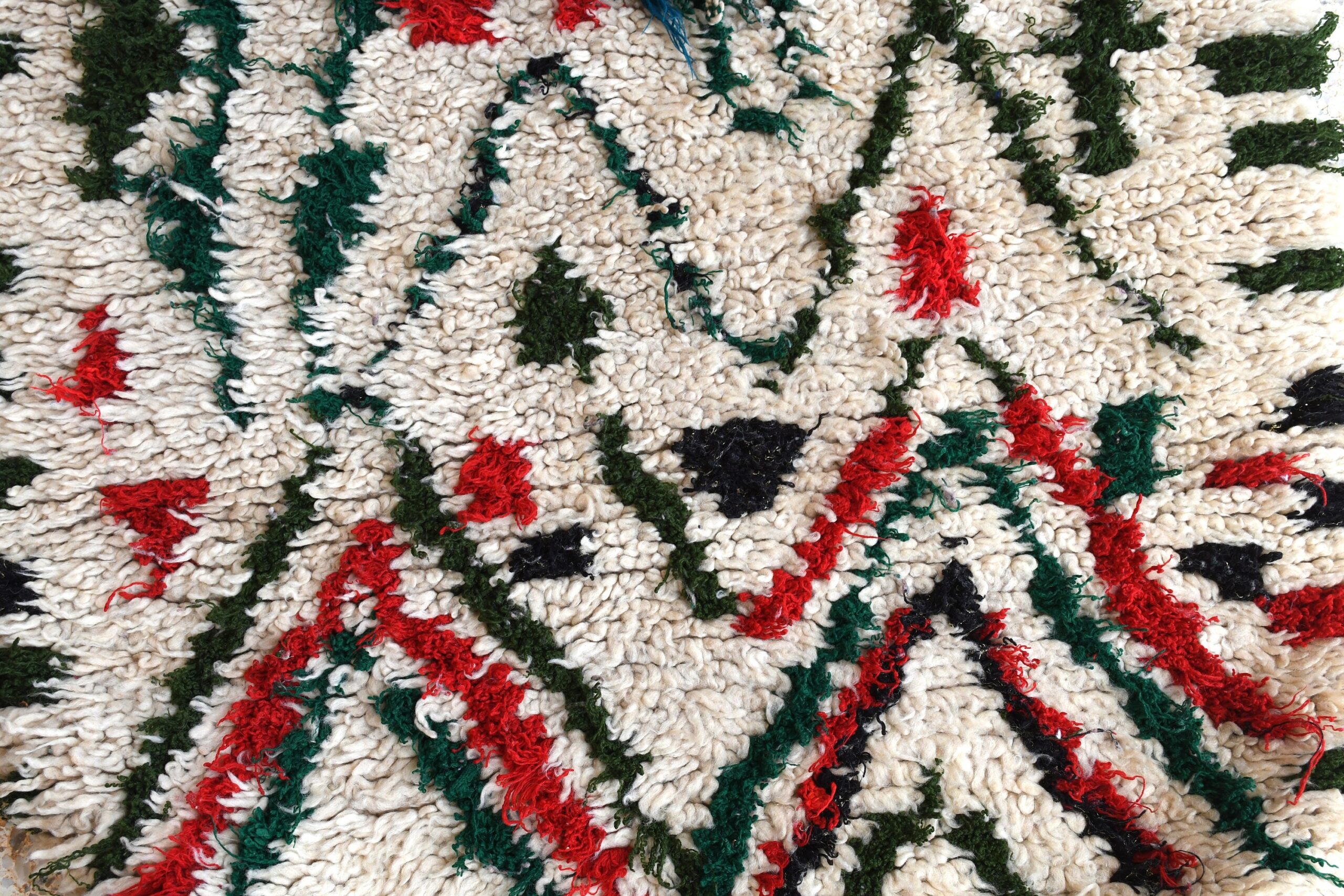 a white rug with red and green flowers. il_fullxfull.6028242188_2p5k.jpg
