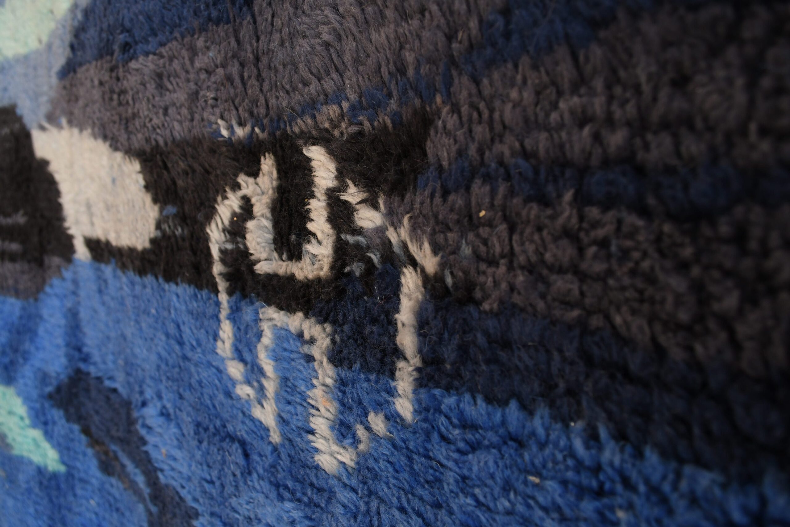 a close up of a blue and black rug. il_fullxfull.6035027698_prdu.jpg