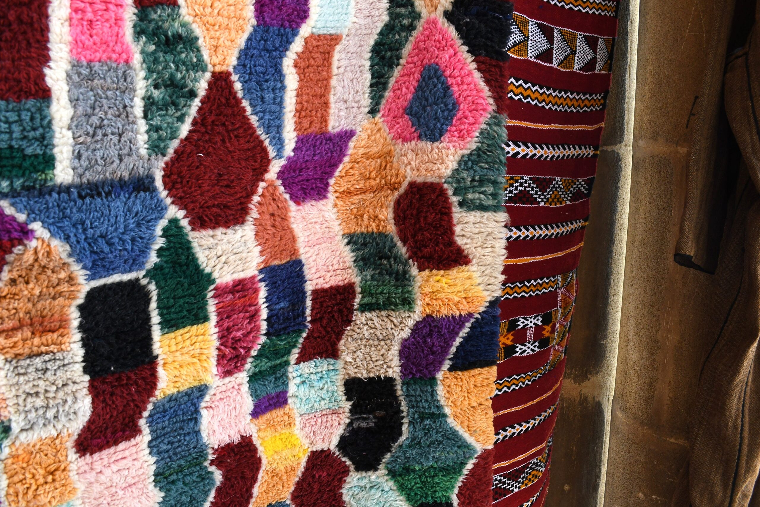 a colorful moroccan rug hanging on a wall. il_fullxfull.6035043044_rww6.jpg