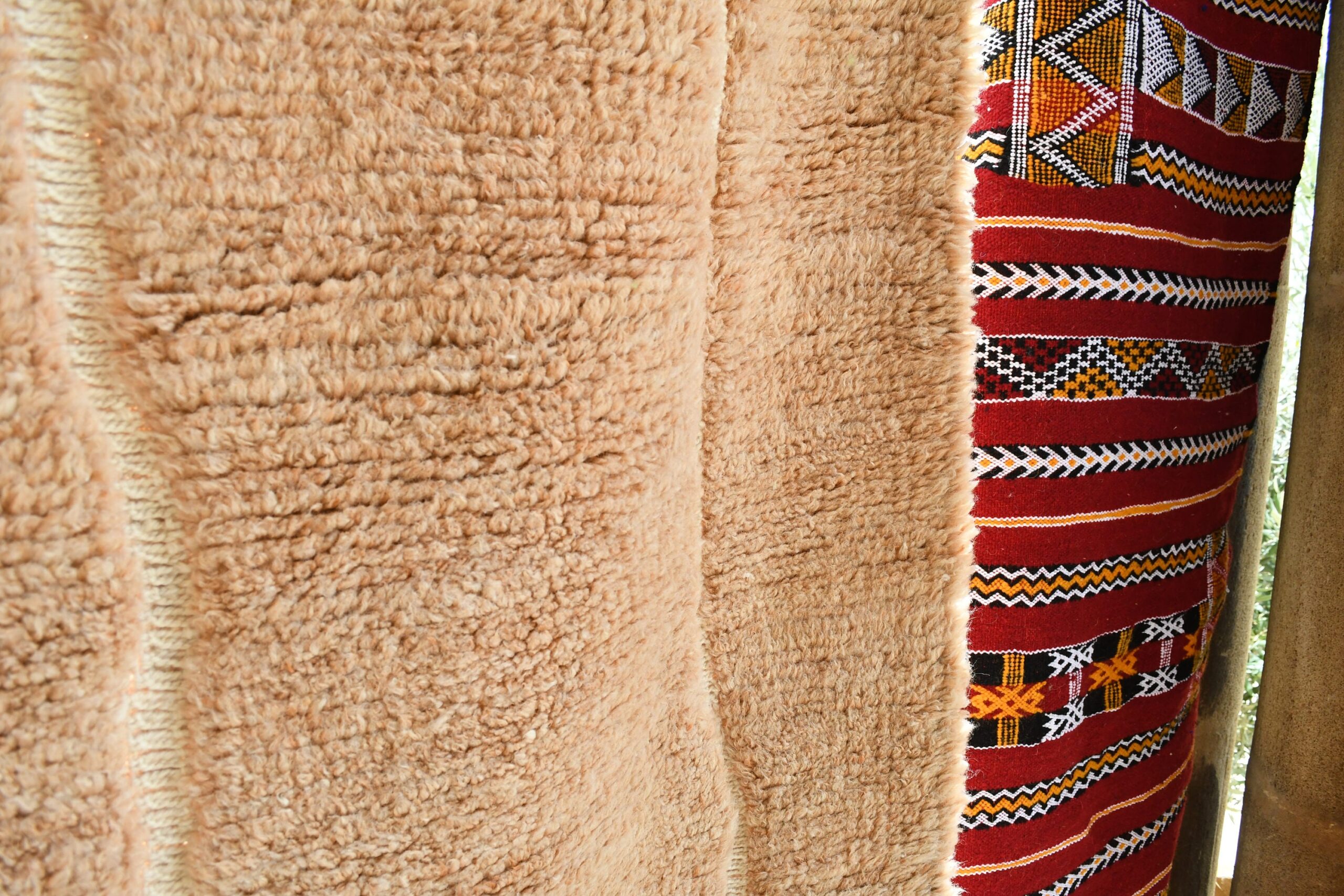 a moroccan rug hanging on a wooden fence. il_fullxfull.6035044926_a9e4.jpg