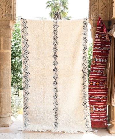 a woman standing in a doorway with a rug. il_fullxfull.6035067676_646b.jpg