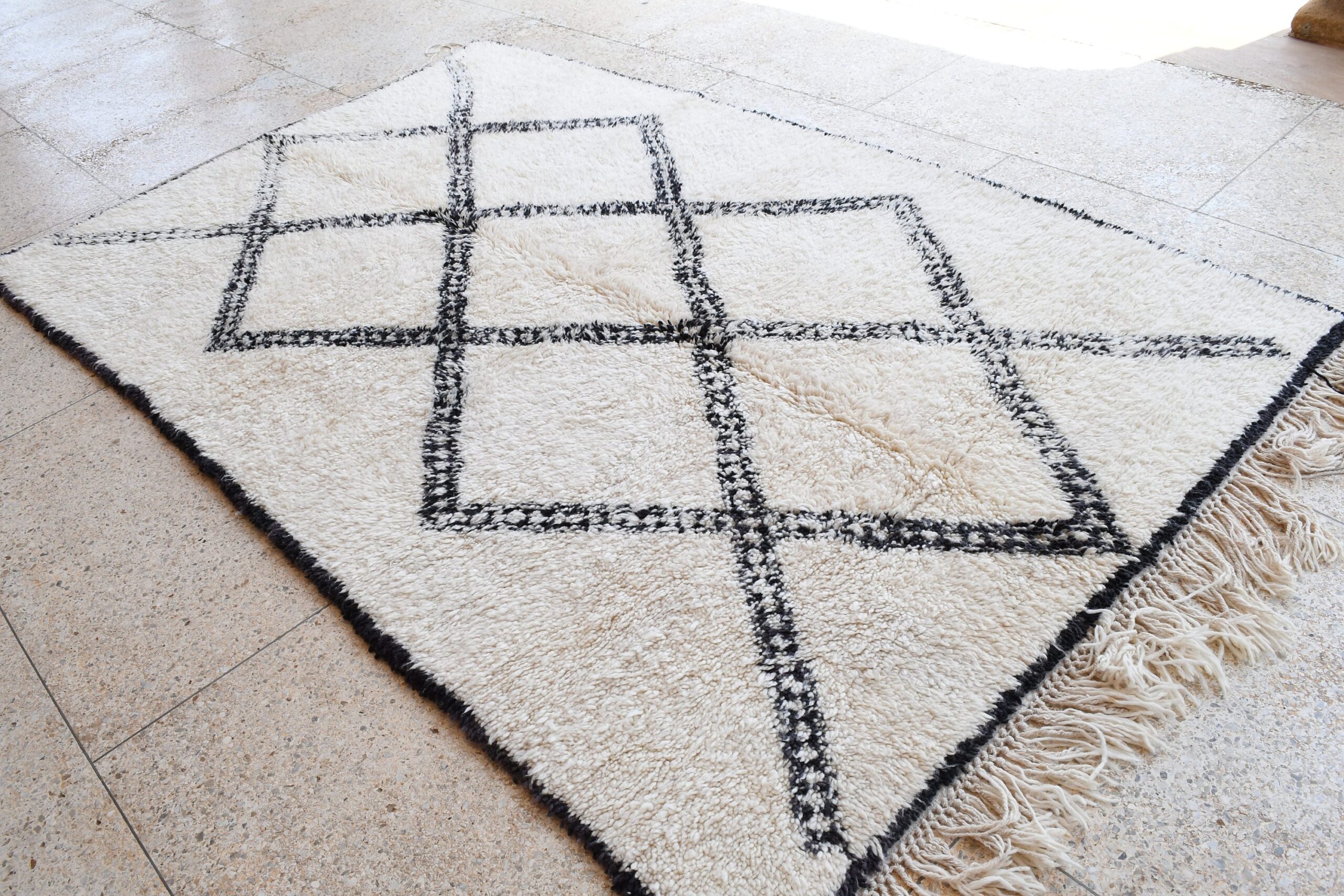 a rug with a black and white design. il_fullxfull.6035070490_h0md.jpg