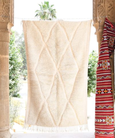 a large white moroccan rug. il_fullxfull.6035074788_szkw.jpg